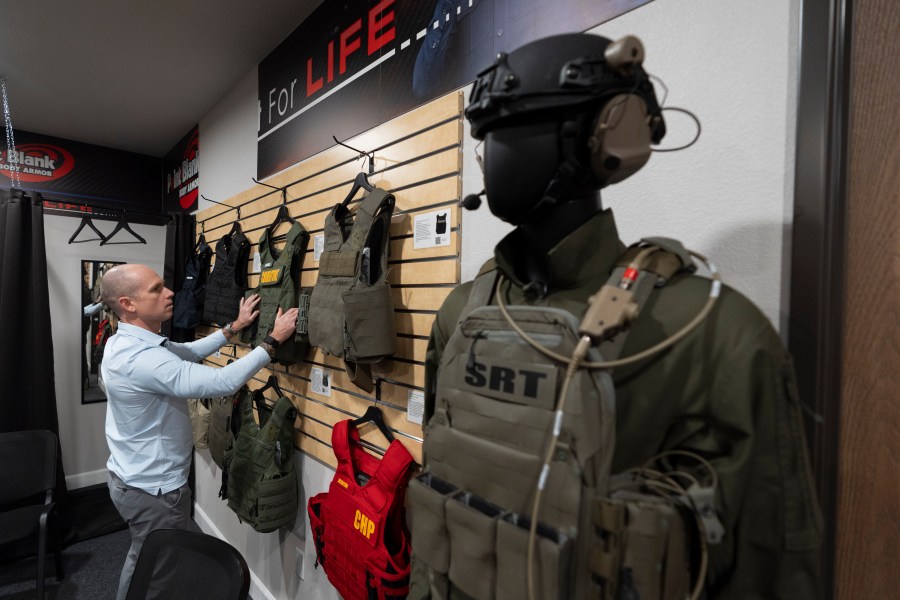 Veteran and business owner Jackson Dalton arranges protective gear at the Black Box Safety offices, Thursday, Nov. 7, 2024, in El Cajon, Calif. (AP Photo/Gregory Bull)