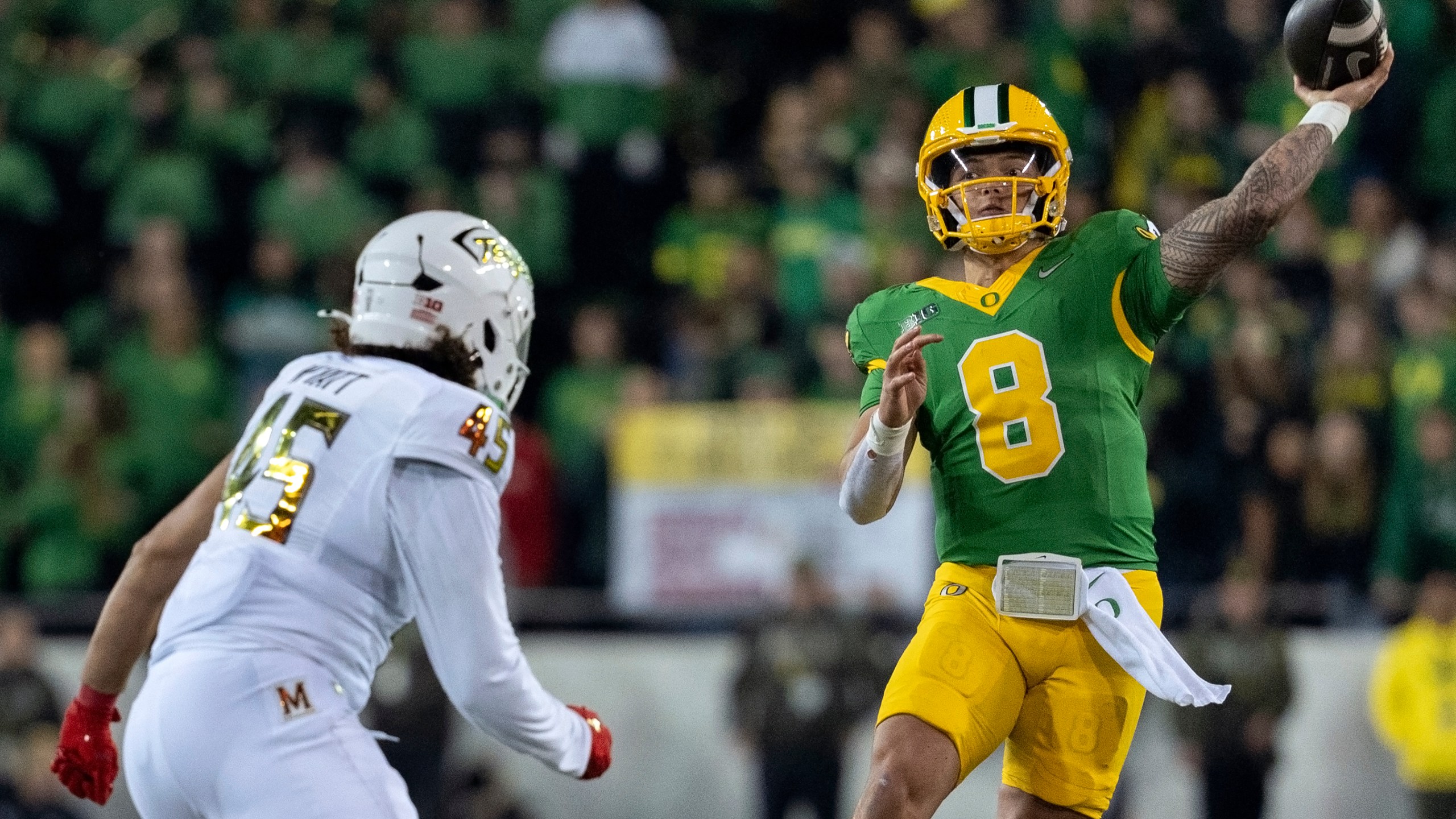 Oregon quarterback Dillon Gabriel (8) throws the ball as Maryland linebacker Kellan Wyatt (45) defends during the second half of an NCAA college football game on Saturday, Nov. 9, 2024, in Eugene, Ore. Oregon won 39-18. (AP Photo/Jenny Kane)