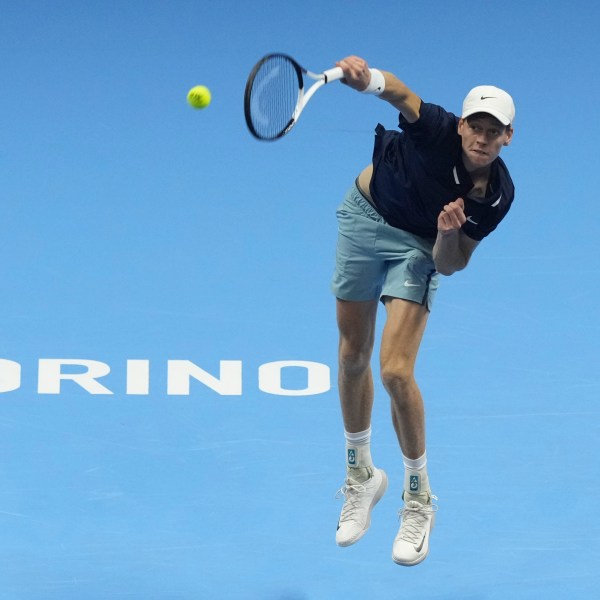 Italy's Jannik Sinner serves the ball to Australia's Alex de Minaur during their singles tennis match of the ATP World Tour Finals at the Inalpi Arena, in Turin, Italy, Sunday, Nov. 10, 2024. (AP Photo/Antonio Calanni)