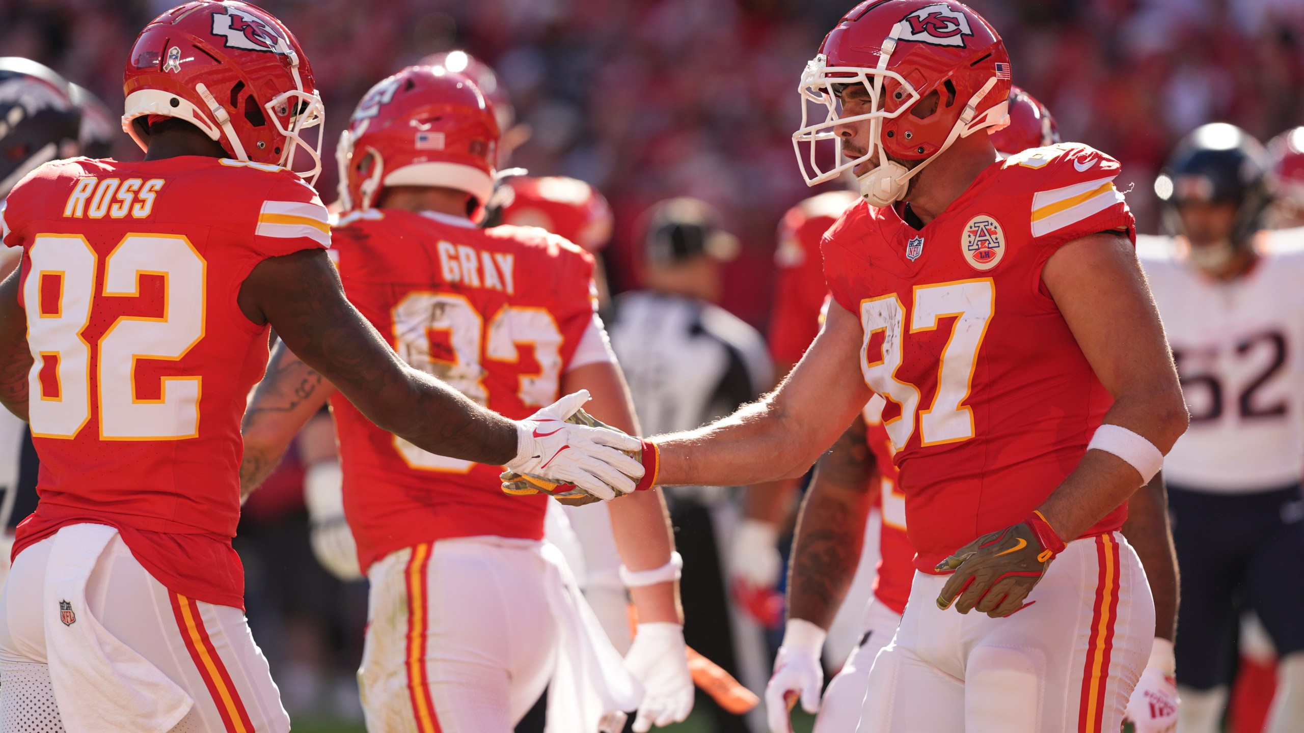 Kansas City Chiefs tight end Travis Kelce (87) is congratulated by Justyn Ross (82) after catching a touchdown pass during the first half of an NFL football game against the Denver Broncos Sunday, Nov. 10, 2024, in Kansas City, Mo. (AP Photo/Charlie Riedel)