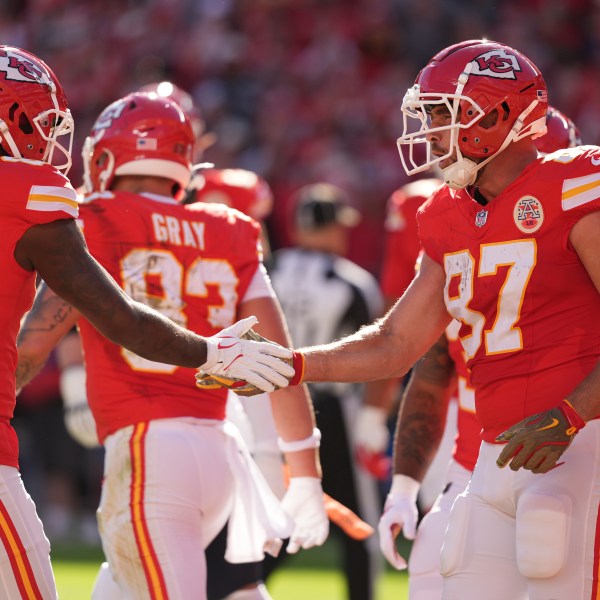 Kansas City Chiefs tight end Travis Kelce (87) is congratulated by Justyn Ross (82) after catching a touchdown pass during the first half of an NFL football game against the Denver Broncos Sunday, Nov. 10, 2024, in Kansas City, Mo. (AP Photo/Charlie Riedel)