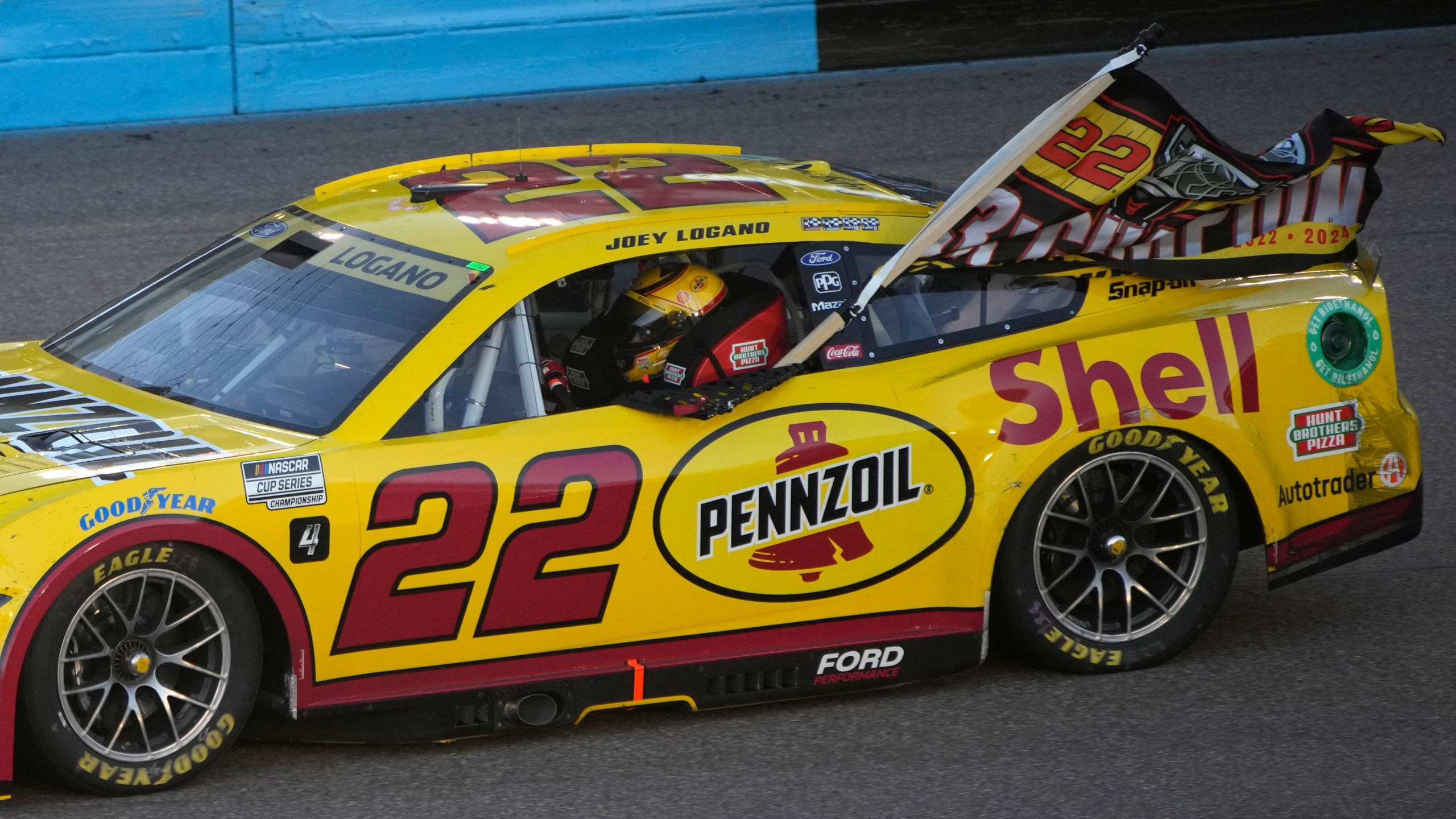 Joey Logano does a victory lap after winning a NASCAR Cup Series Championship auto race for the championship at Phoenix Raceway, Sunday, Nov. 10, 2024, in Avondale, Ariz. (AP Photo/John Locher)