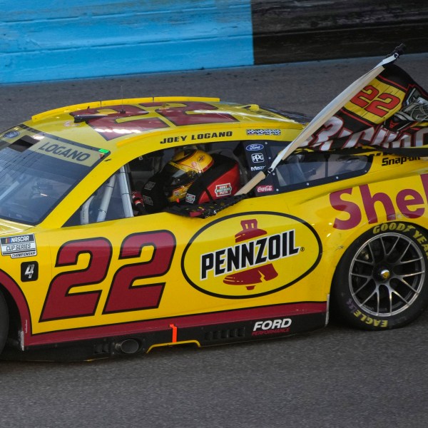 Joey Logano does a victory lap after winning a NASCAR Cup Series Championship auto race for the championship at Phoenix Raceway, Sunday, Nov. 10, 2024, in Avondale, Ariz. (AP Photo/John Locher)