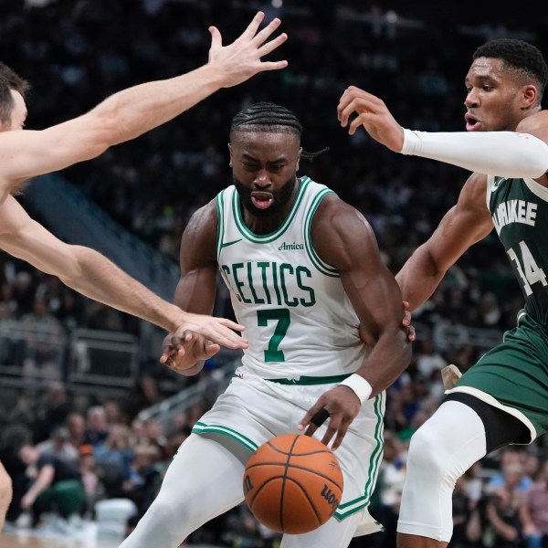 Boston Celtics' Jaylen Brown drives between Milwaukee Bucks' Pat Connaughton and Giannis Antetokounmpo during the first half of an NBA basketball game Sunday, Nov. 10, 2024, in Milwaukee. (AP Photo/Morry Gash)