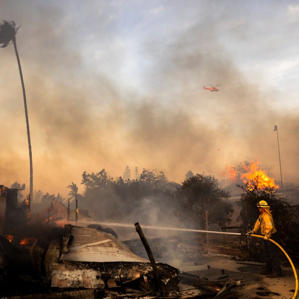 Firefighters work against the Mountain Fire, Nov. 6, 2024, near Camarillo, Calif. (AP Photo/Ethan Swope)