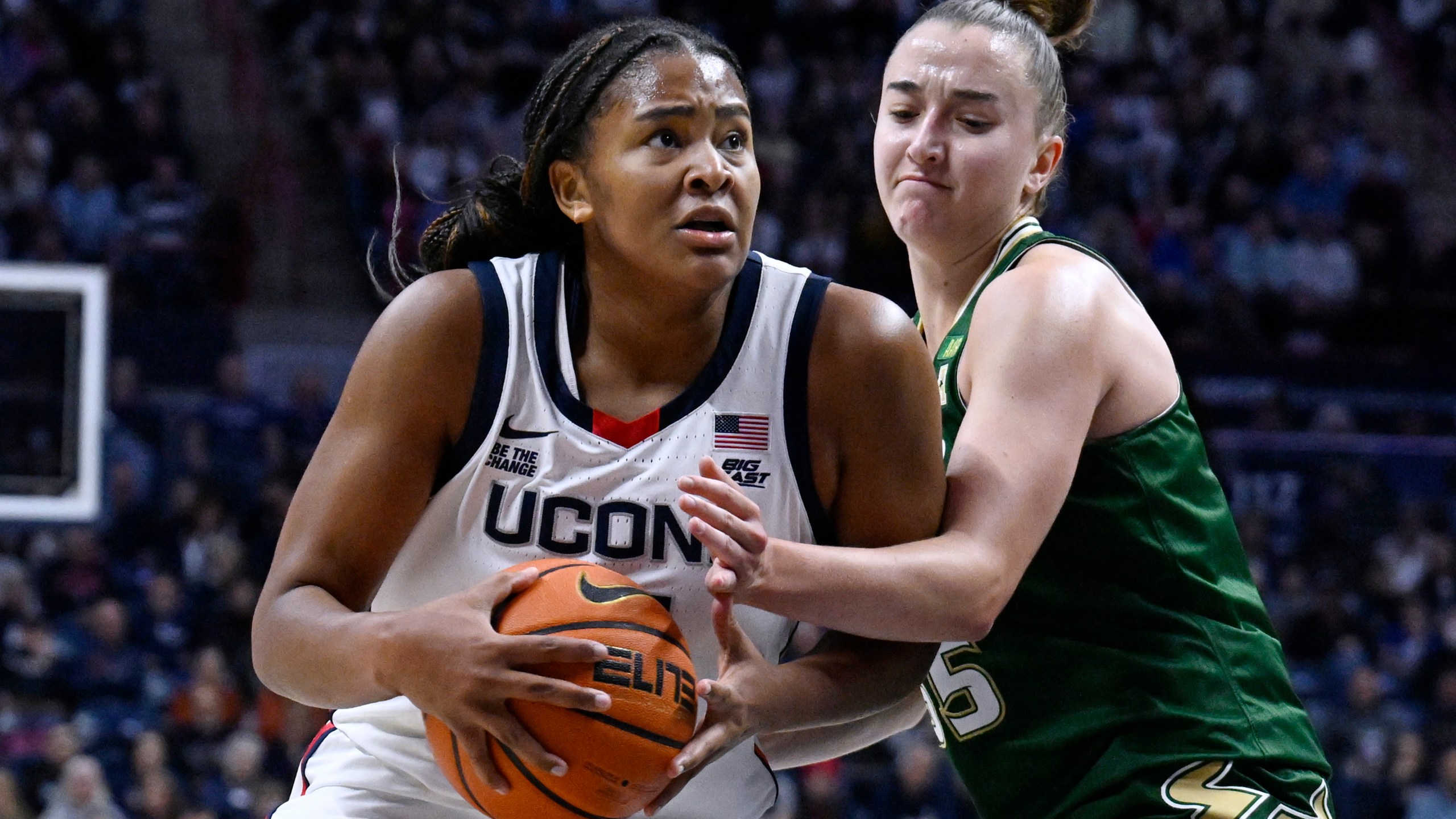 UConn forward Sarah Strong, left, is guarded by South Florida guard Carla Brito in the first half of an NCAA college basketball game, Sunday, Nov. 10, 2024, in Storrs, Conn. (AP Photo/Jessica Hill)