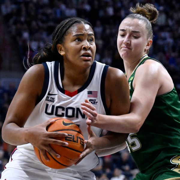 UConn forward Sarah Strong, left, is guarded by South Florida guard Carla Brito in the first half of an NCAA college basketball game, Sunday, Nov. 10, 2024, in Storrs, Conn. (AP Photo/Jessica Hill)