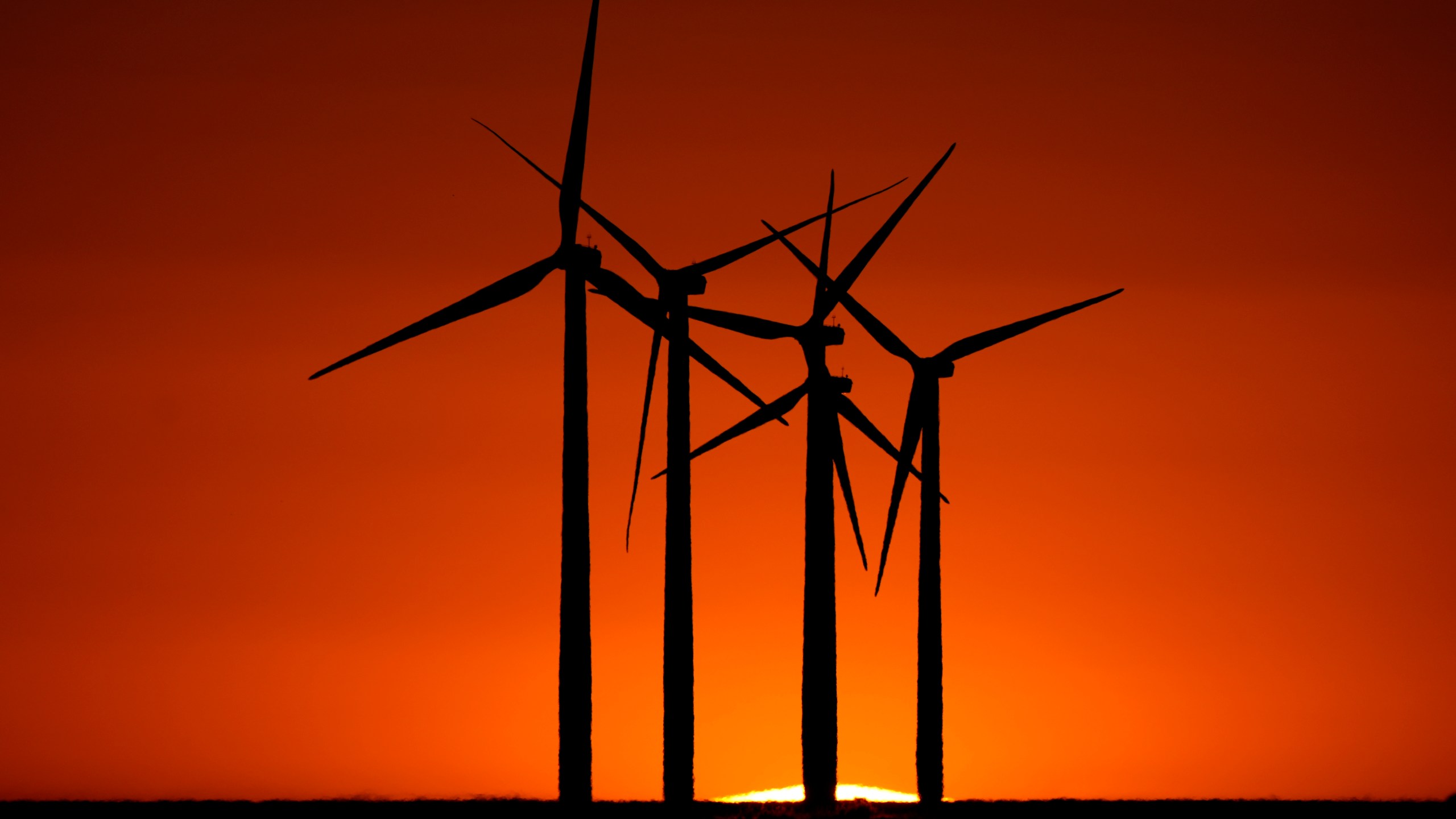 Wind turbines are silhouetted against the setting sun at the Spearville Wind Farm, Sunday, Sept. 29, 2024, near Spearville, Kan. (AP Photo/Charlie Riedel)