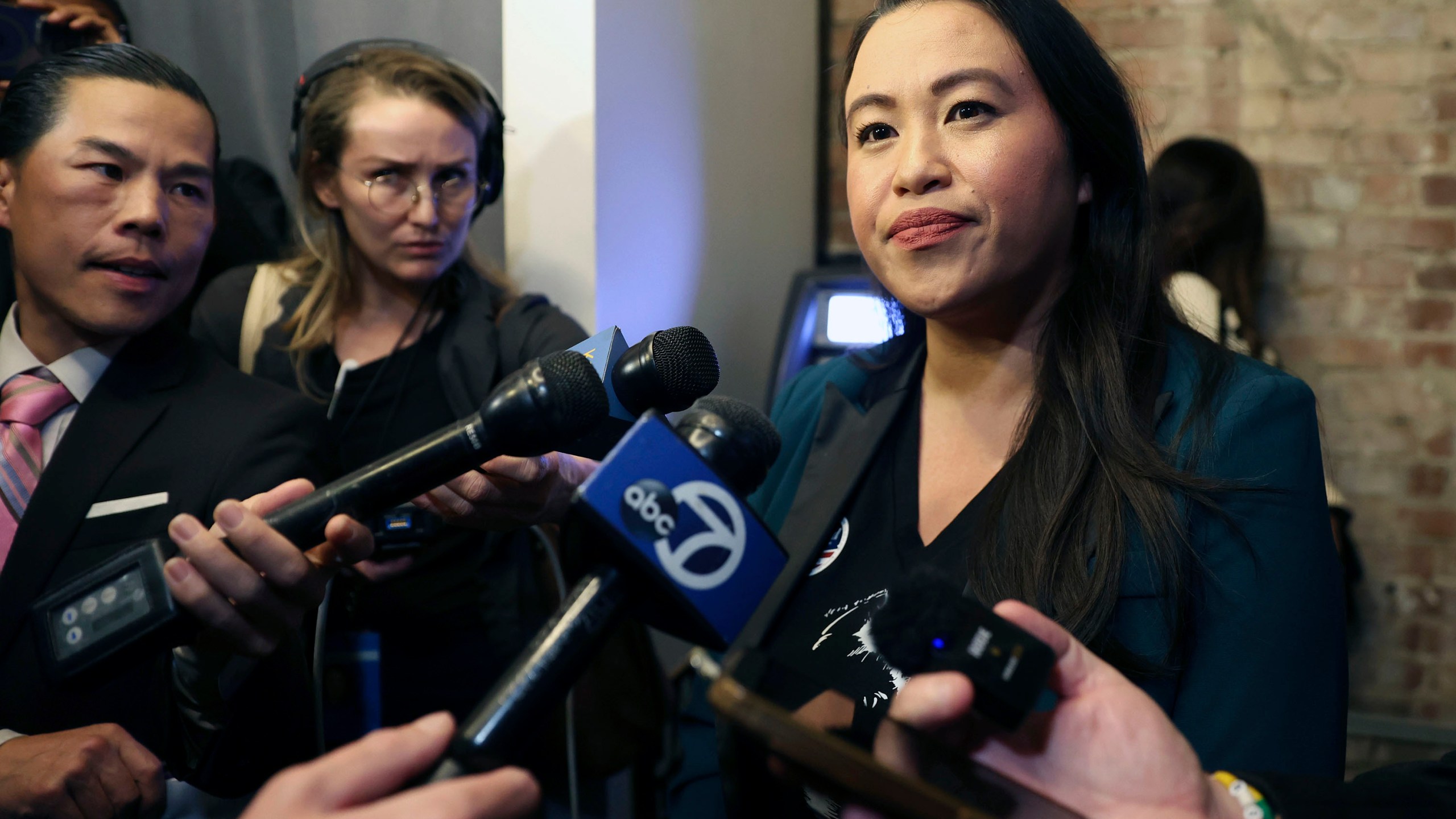 Oakland Mayor Sheng Thao, right, listens to a question from the media during an election night gathering at Fluid 510 in Oakland, Calif., Tuesday, Nov. 5, 2024. (Scott Strazzante/San Francisco Chronicle via AP)