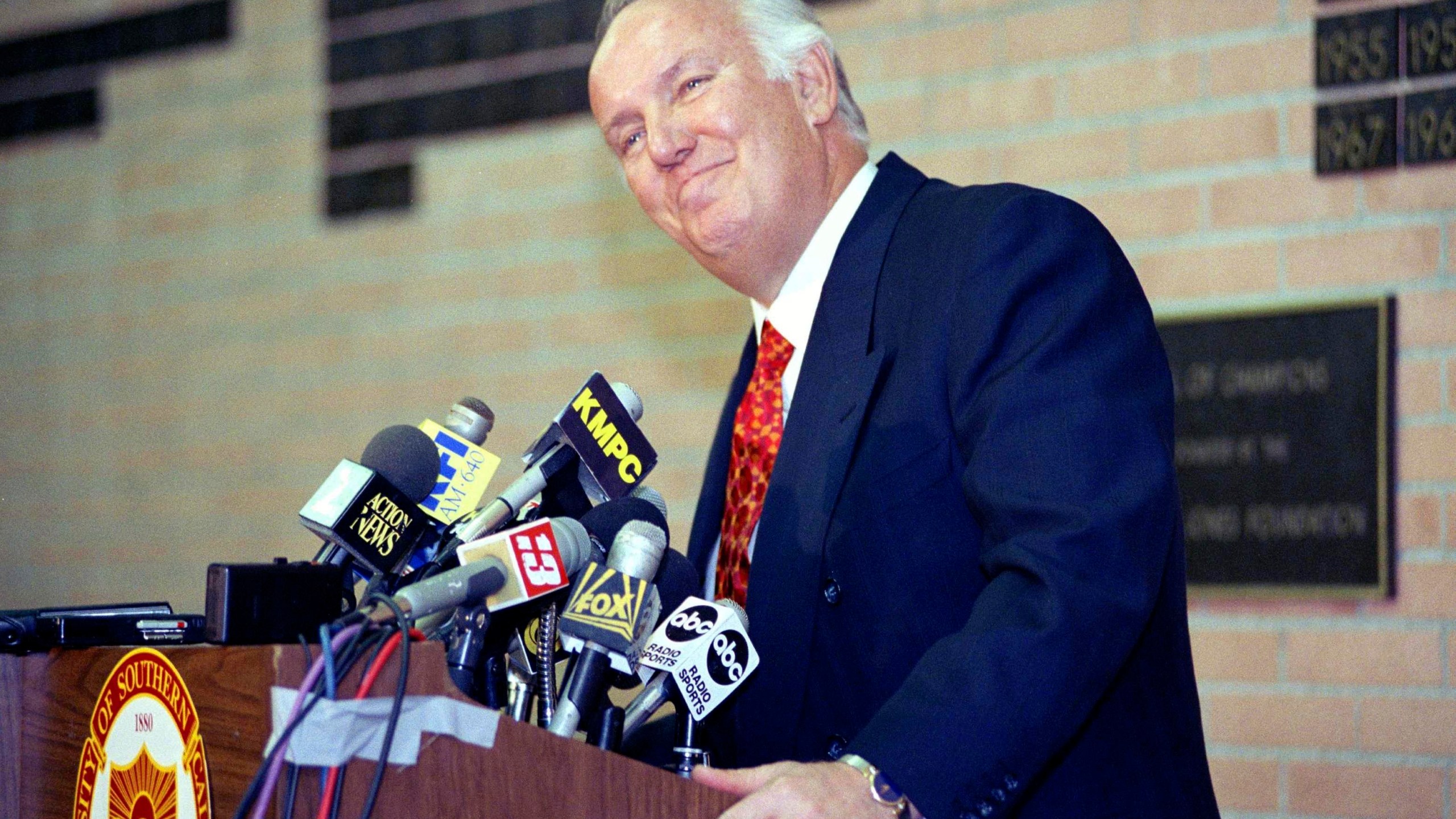 FILE - Former head coach of the Los Angeles Rams John Robinson addresses the media in Los Angeles, Jan. 3, 1992. (AP Photo/Chris Martinez, File)