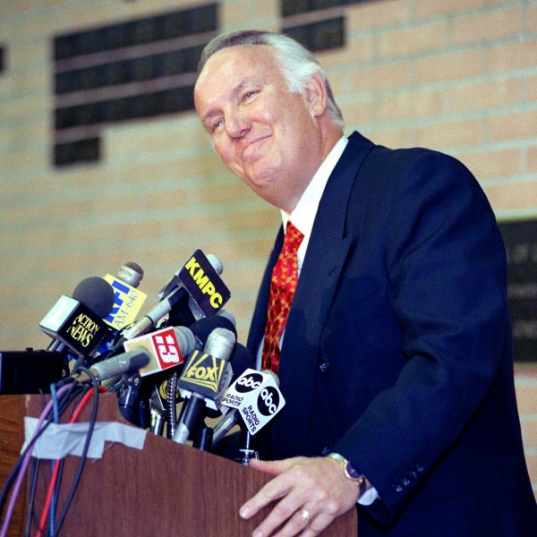 FILE - Former head coach of the Los Angeles Rams John Robinson addresses the media in Los Angeles, Jan. 3, 1992. (AP Photo/Chris Martinez, File)