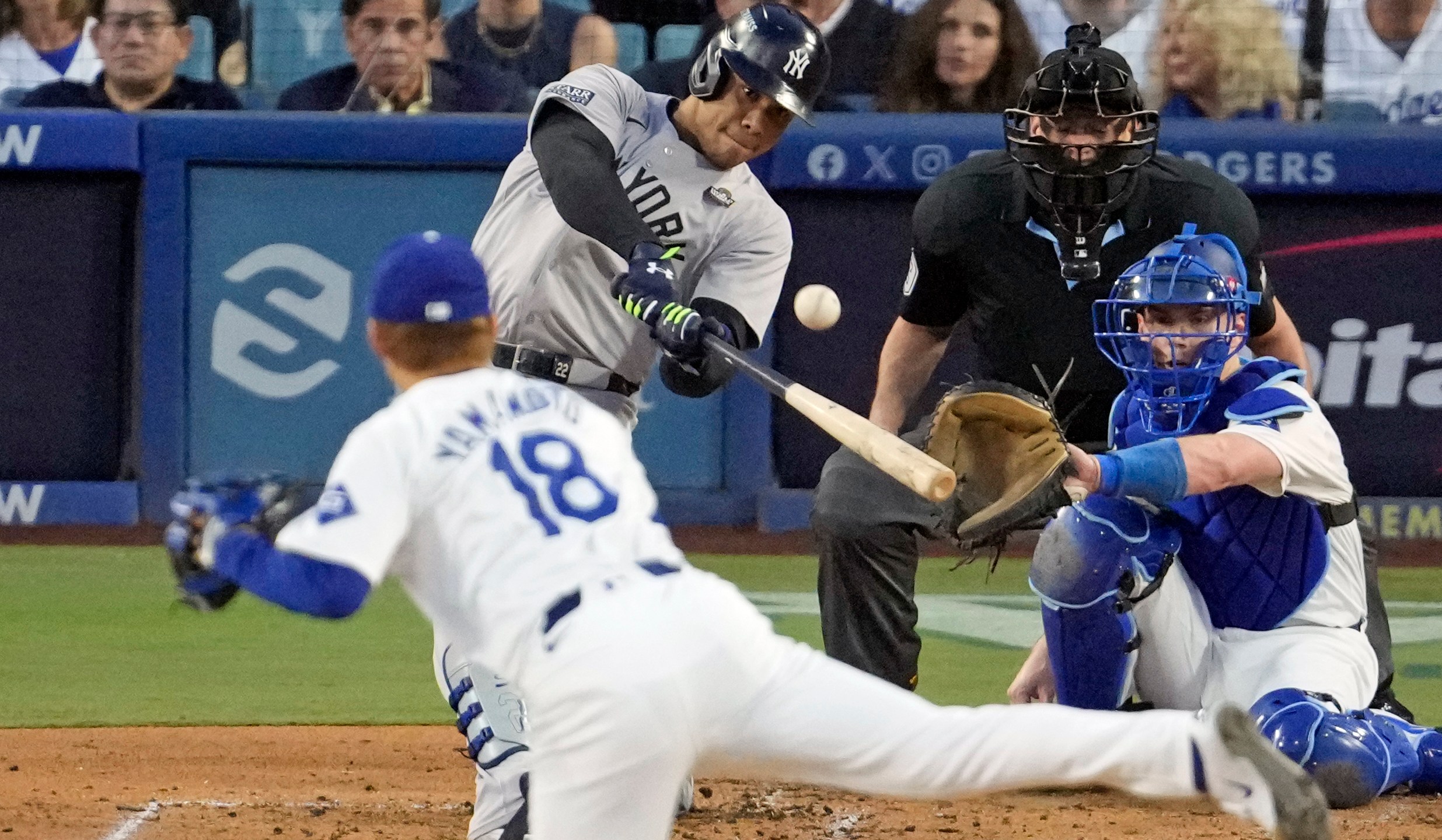 New York Yankees' Juan Soto, center, hits a home run off Los Angeles Dodgers starting pitcher Yoshinobu Yamamoto (18) during the third inning in Game 2 of the baseball World Series, Saturday, Oct. 26, 2024, in Los Angeles. (AP Photo/Julio Cortez)