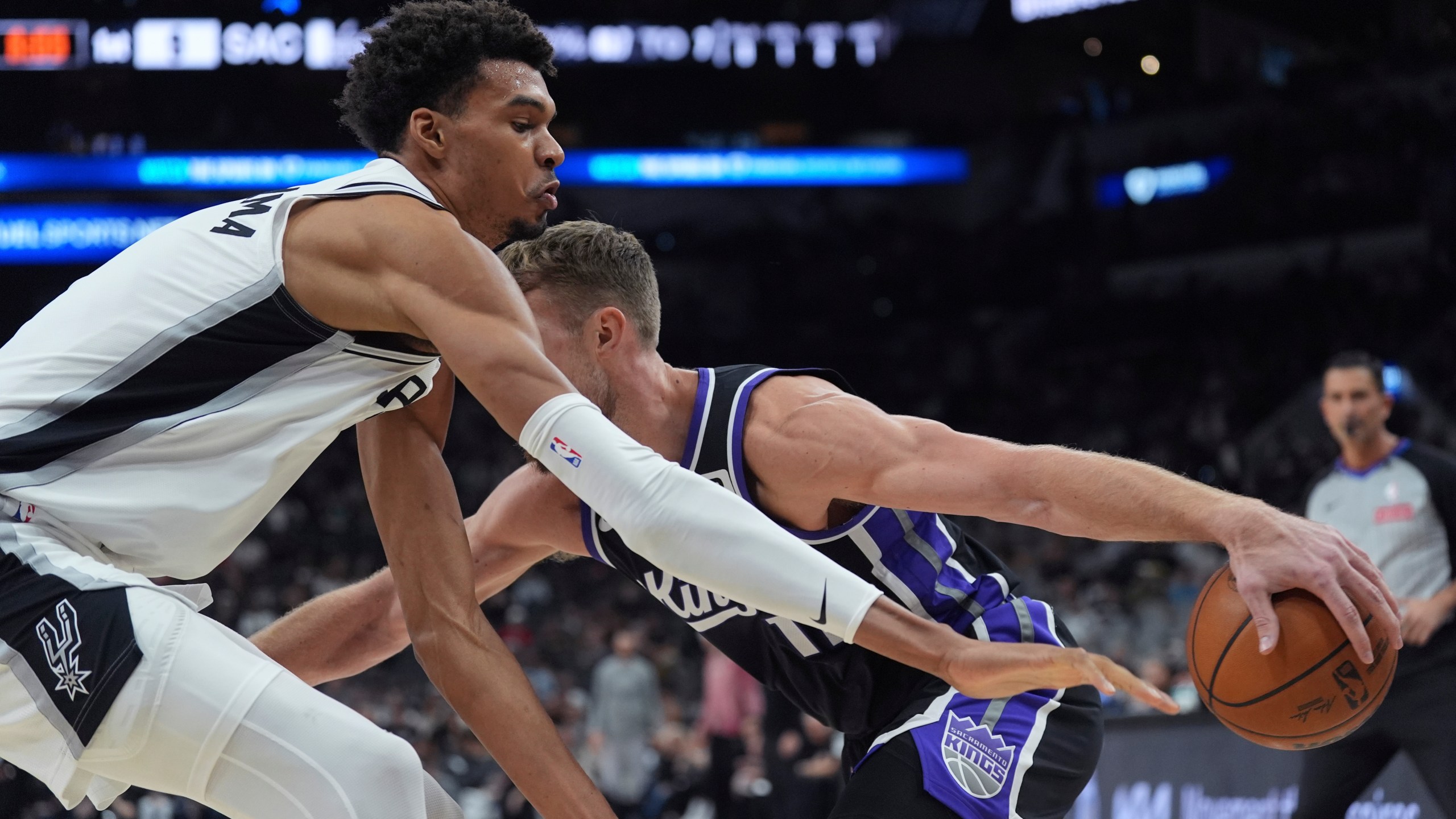 Sacramento Kings forward Domantas Sabonis tries to drive against San Antonio Spurs center Victor Wembanyama during the first half of an NBA basketball game in San Antonio, Monday, Nov. 11, 2024. (AP Photo/Eric Gay)