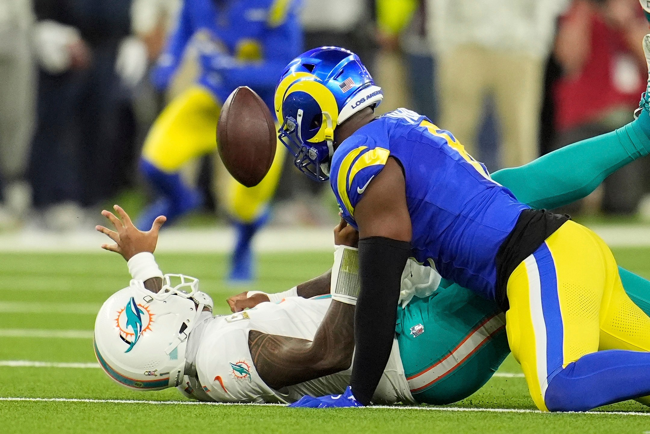 Los Angeles Rams linebacker Jared Verse, right, forces a fumble on Miami Dolphins quarterback Tua Tagovailoa during the first half of an NFL football game, Monday, Nov. 11, 2024, in Inglewood, Calif. The Rams recovered the ball. (AP Photo/Marcio Jose Sanchez)