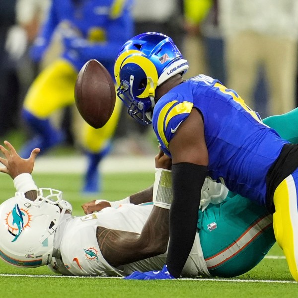 Los Angeles Rams linebacker Jared Verse, right, forces a fumble on Miami Dolphins quarterback Tua Tagovailoa during the first half of an NFL football game, Monday, Nov. 11, 2024, in Inglewood, Calif. The Rams recovered the ball. (AP Photo/Marcio Jose Sanchez)