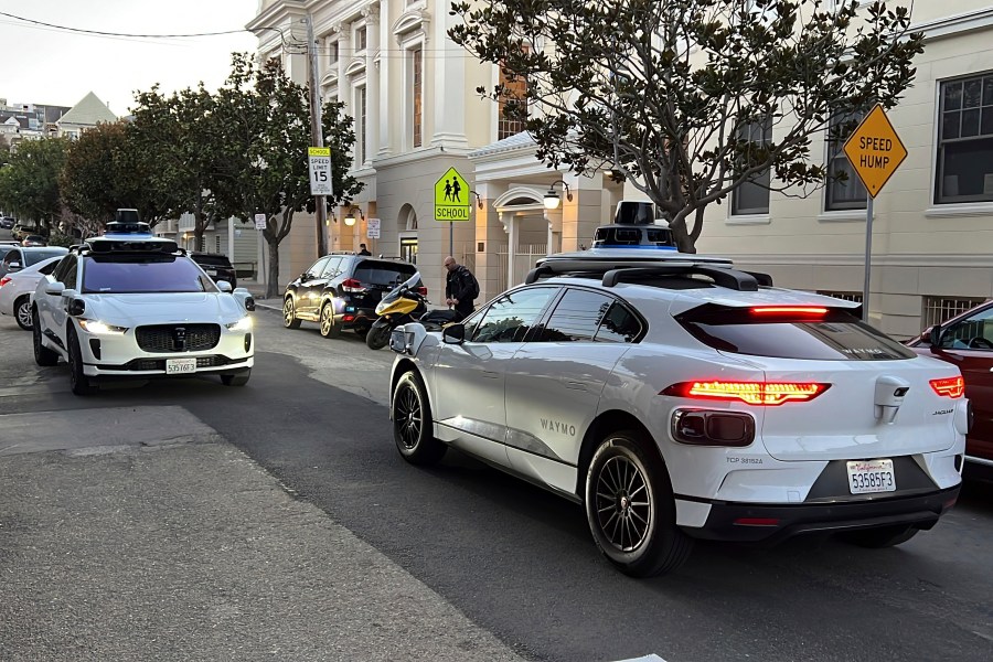 FILE - Two Waymo driverless taxis stop before passing one another on a San Francisco street on Feb. 15, 2023. (AP Photo/Terry Chea, File)