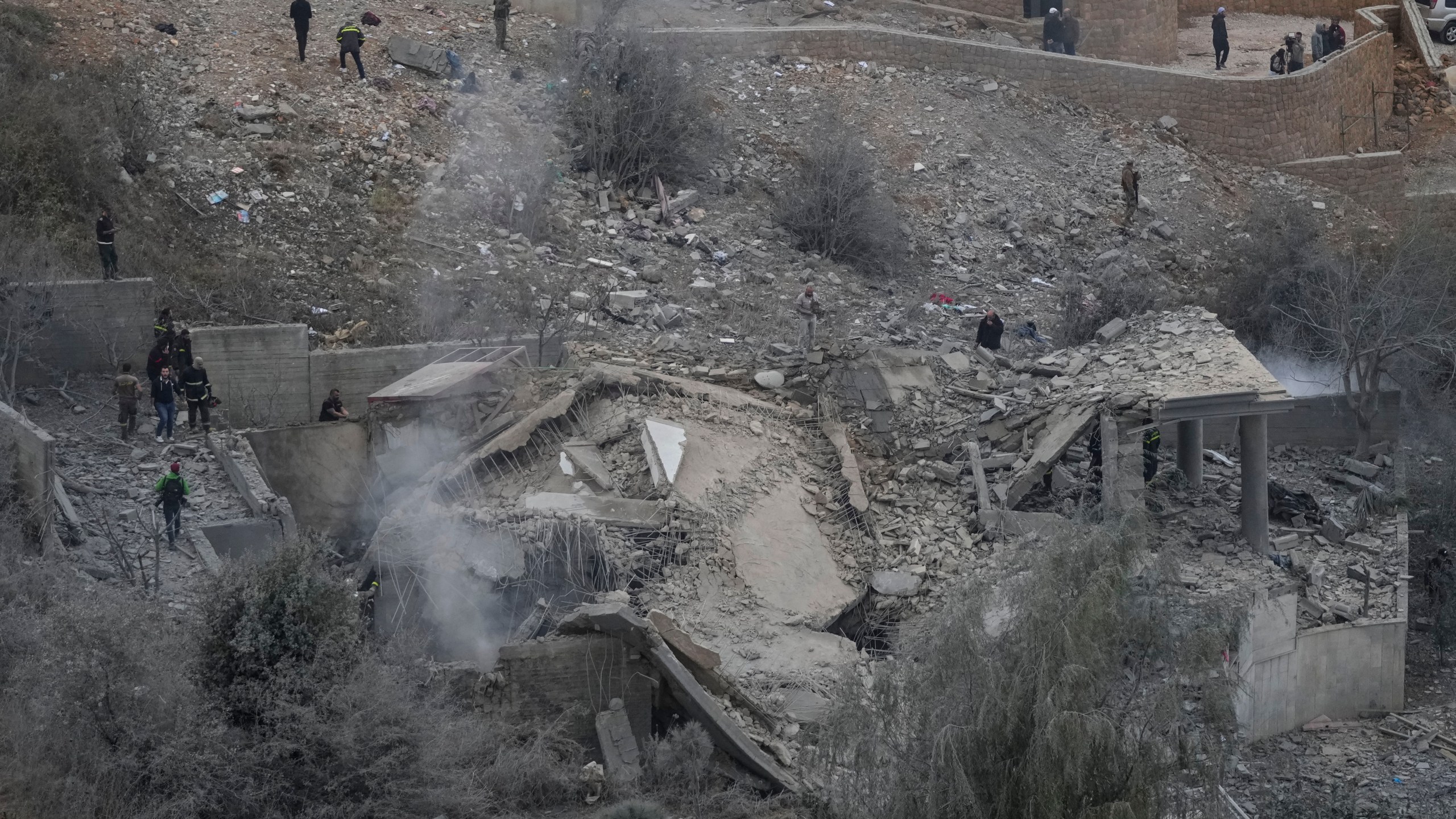 Rescue workers search for victims at a house hit in an Israeli airstrike in Baalchmay village east of Beirut, Lebanon, Tuesday, Nov. 12, 2024. (AP Photo/Hassan Ammar)