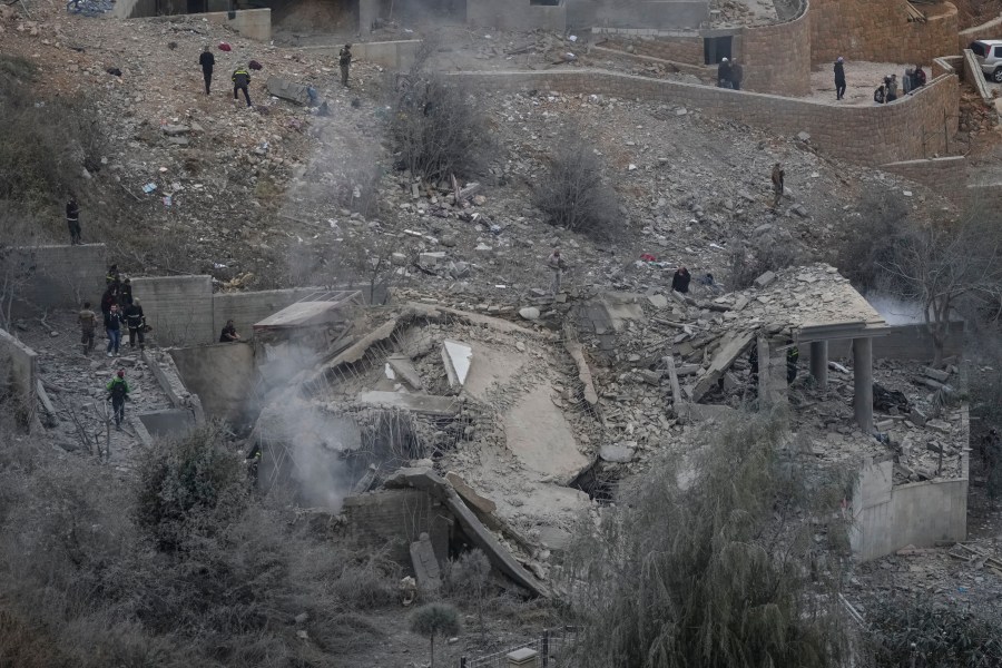 Rescue workers search for victims at a house hit in an Israeli airstrike in Baalchmay village east of Beirut, Lebanon, Tuesday, Nov. 12, 2024. (AP Photo/Hassan Ammar)