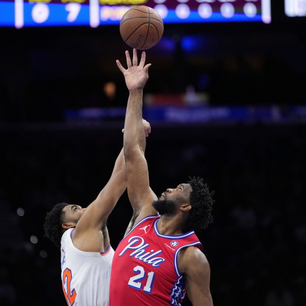 Philadelphia 76ers' Joel Embiid, right, and New York Knicks' Karl-Anthony Towns reach for the tipoff during the first half of an Emirates NBA Cup basketball game, Tuesday, Nov. 12, 2024, in Philadelphia. (AP Photo/Matt Slocum)