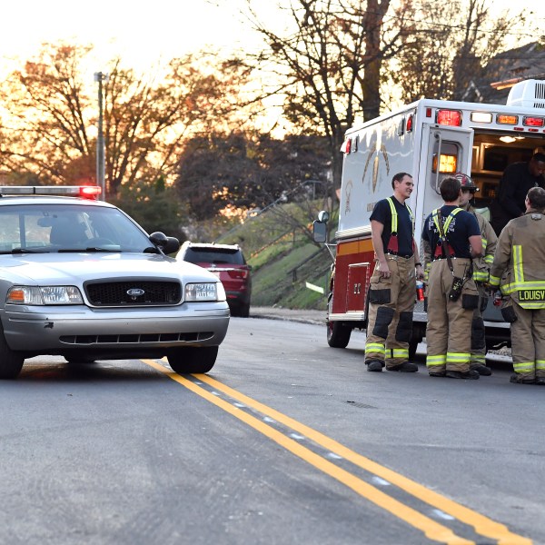 Members of the Louisville Fire Departments check their gear as they prepare to enter Givaudan Sense Colour following an explosion at the facility in Louisville, Ky., Tuesday, Nov. 12, 2024. (AP Photo/Timothy D. Easley)