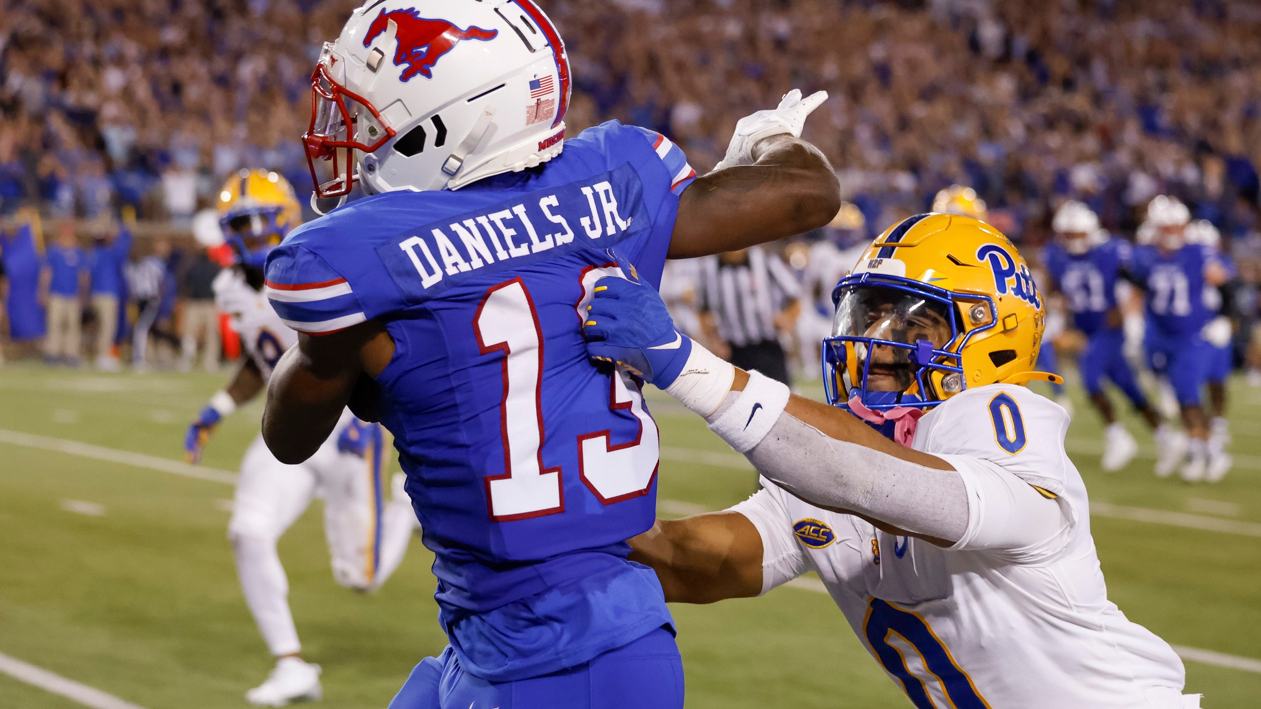 SMU wide receiver Roderick Daniels Jr. (13) is knocked out of bounds by Pittsburgh linebacker Braylan Lovelace (0) during the first half of an NCAA college football game in Dallas, Saturday, Nov. 2, 2024. AP Photo/Gareth Patterson)