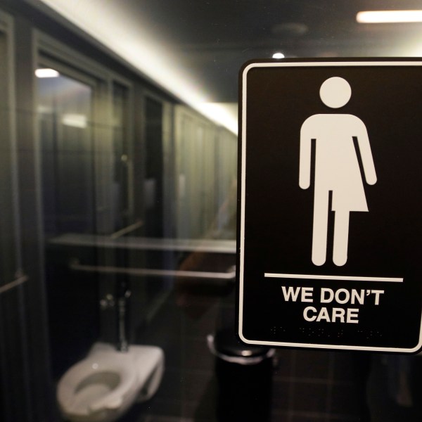 FILE - Signage hangs outside a restroom at 21c Museum Hotel in Durham, N.C., May 12, 2016. (AP Photo/Gerry Broome, File)