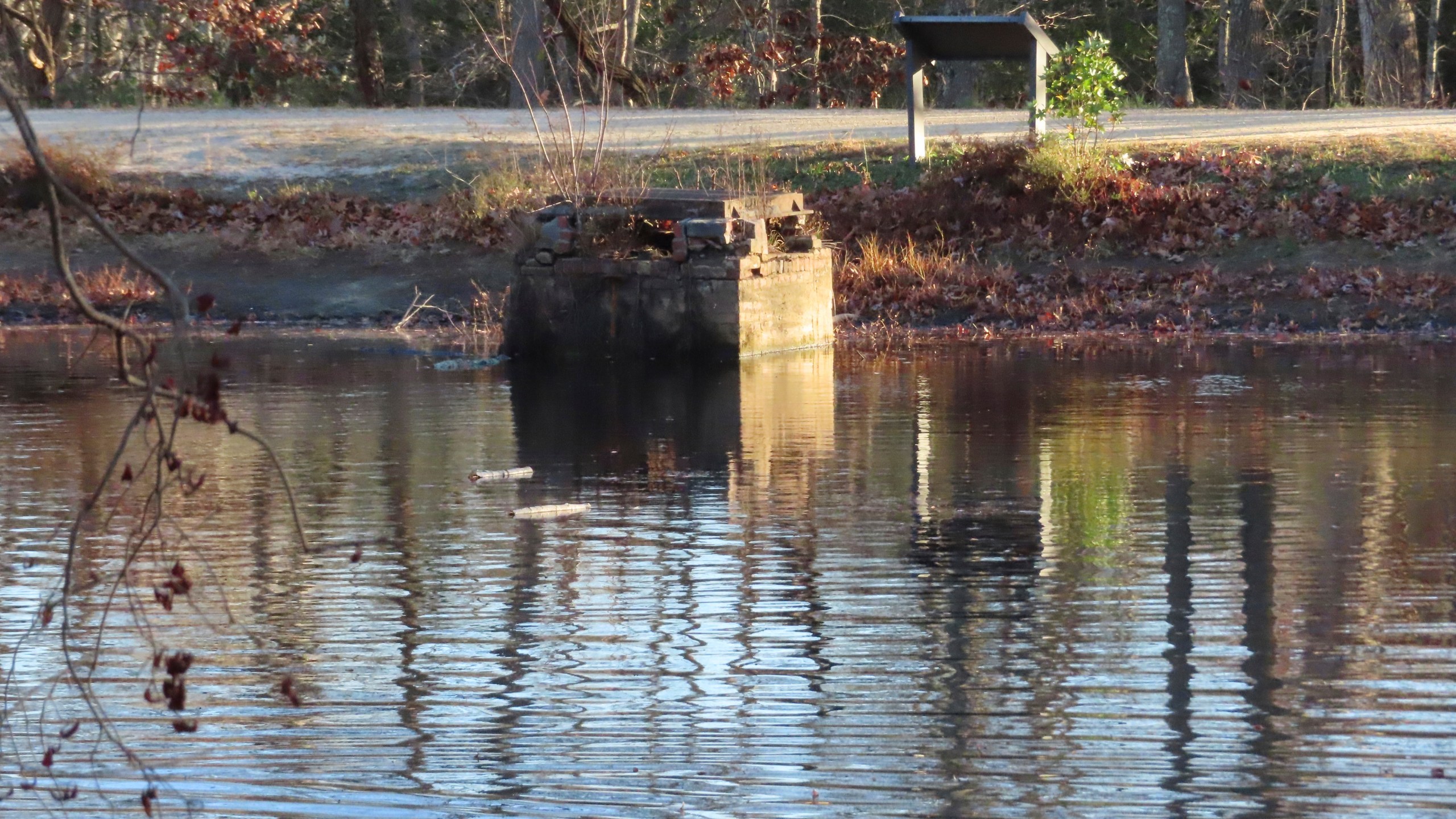 A spillway, designed to keep a pond in Allaire State Park in Wall, N.J., from overflowing under normal conditions, is exposed on Tuesday, Nov. 12, 2024, amid record-breaking dry conditions in New Jersey. (AP Photo/Wayne Parry)