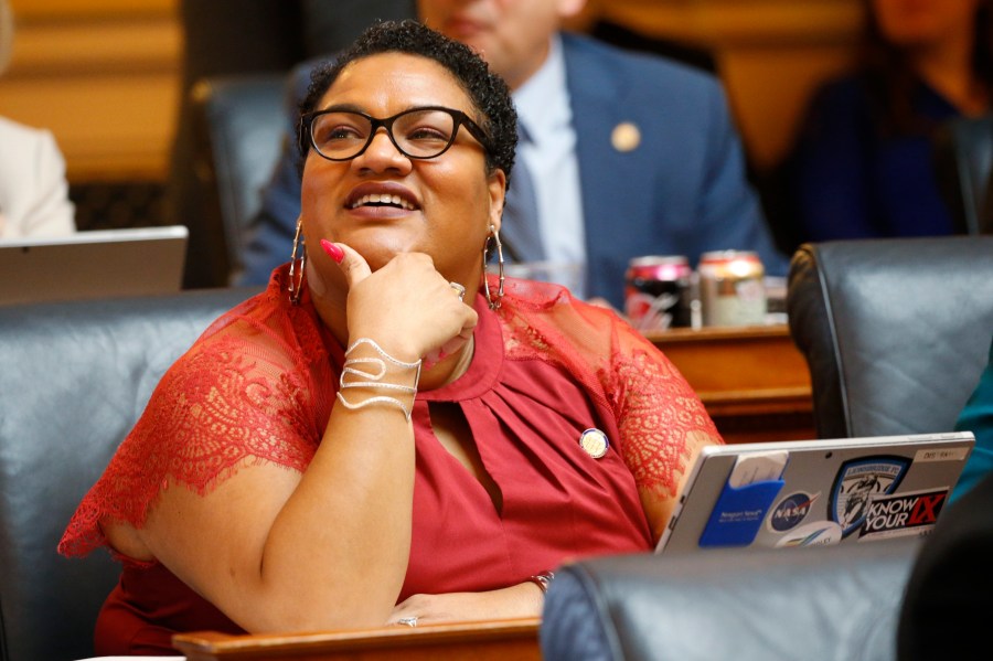 FILE - Del. Marcia 'Cia' Price, D-Newport News, looks at the vote tally board during the House session at the Capitol Wednesday, Feb. 19, 2020, in Richmond, Va. (AP Photo/Steve Helber, File)