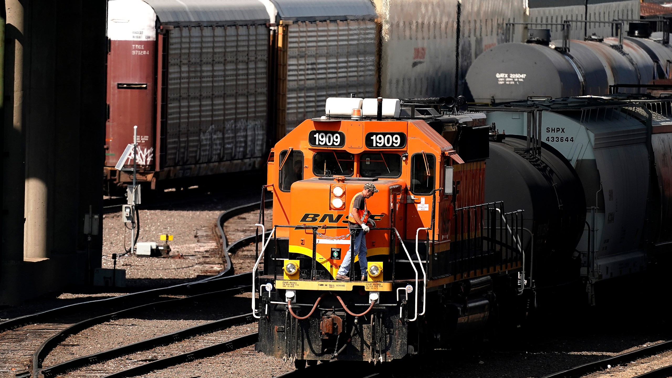 FILE - A worker boards a locomotive at a BNSF rail yard, Sept. 14, 2022, in Kansas City, Kan. (AP Photo/Charlie Riedel, File)