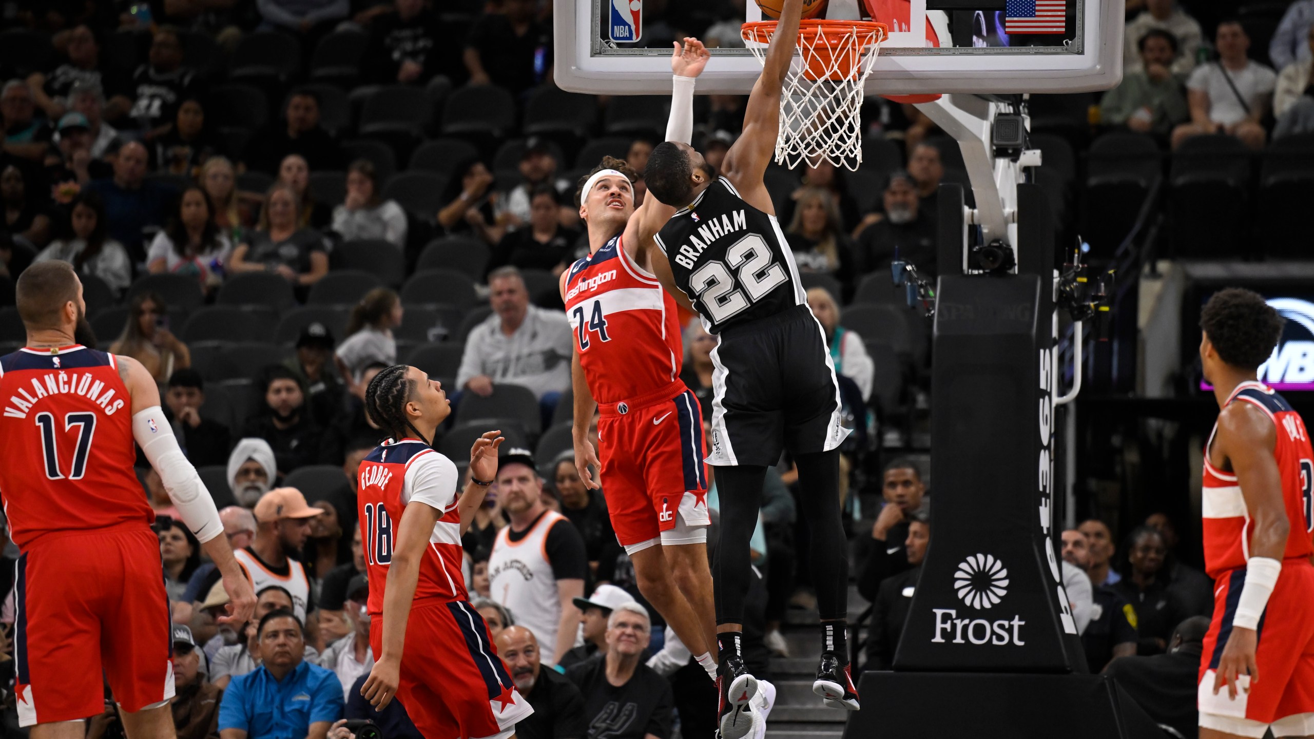 San Antonio Spurs' Malaki Branham (22) dunks against Washington Wizards' Corey Kispert (24) during the first half of an NBA basketball game, Wednesday, Nov. 13, 2024, in San Antonio. (AP Photo/Darren Abate)