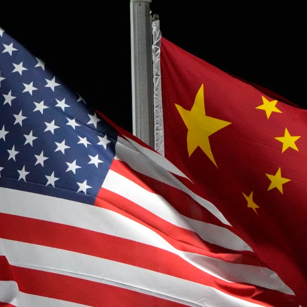 FILE - The American and Chinese flags wave at Genting Snow Park, Feb. 2, 2022, in Zhangjiakou, China. (AP Photo/Kiichiro Sato, File)