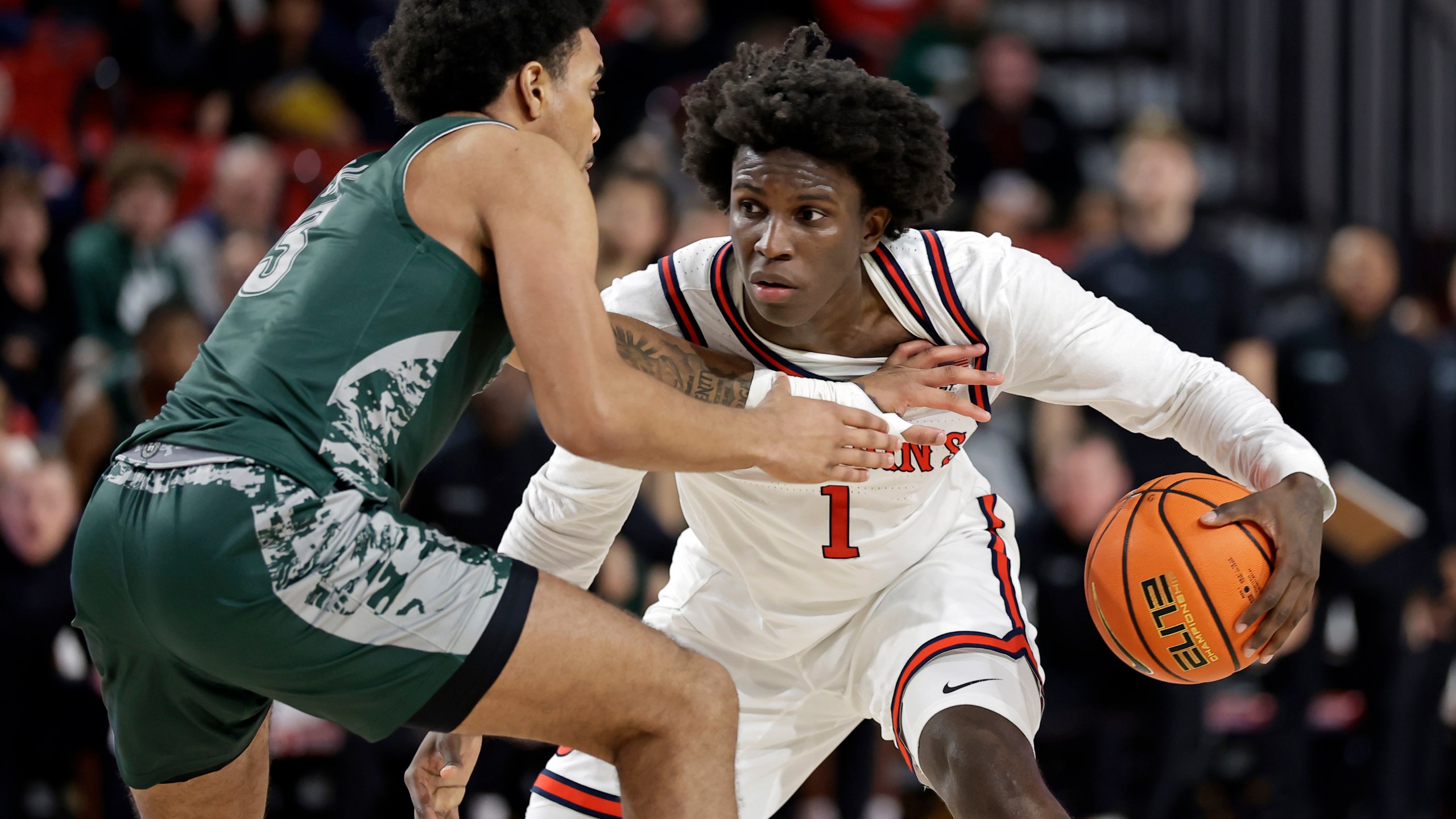 St. John's guard Kadary Richmond (1) looks to drive around Wagner guard Ja'Kair Sanchez during the second half of an NCAA college basketball game Wednesday, Nov. 13, 2024, in New York. St. John's won 66-45. (AP Photo/Adam Hunger)