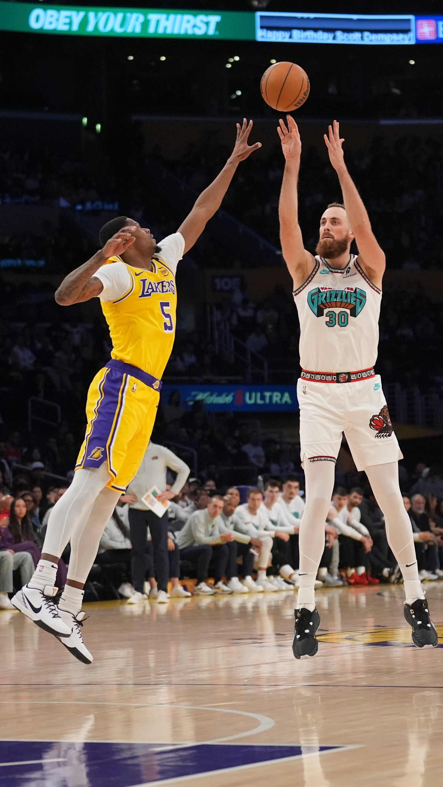 Memphis Grizzlies center Jay Huff (30) shoots over Los Angeles Lakers forward Cam Reddish (5) during the first half of an NBA basketball game Wednesday, Nov. 13, 2024, in Los Angeles. (AP Photo/Marcio Jose Sanchez)