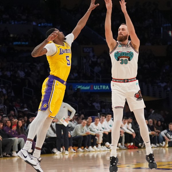 Memphis Grizzlies center Jay Huff (30) shoots over Los Angeles Lakers forward Cam Reddish (5) during the first half of an NBA basketball game Wednesday, Nov. 13, 2024, in Los Angeles. (AP Photo/Marcio Jose Sanchez)