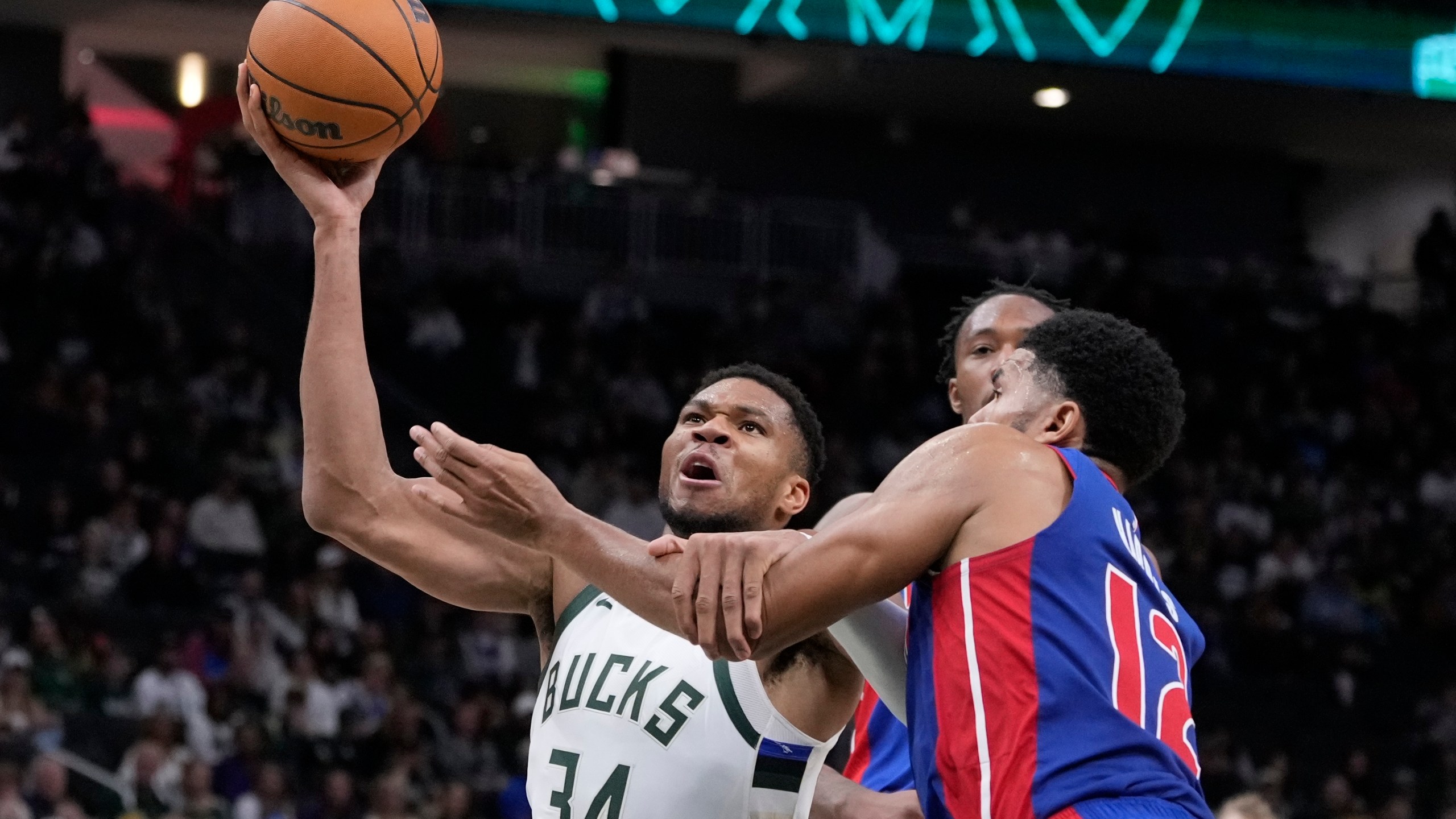 Detroit Pistons' Tobias Harris fouls Milwaukee Bucks' Giannis Antetokounmpo during the second half of an NBA basketball game Wednesday, Nov. 13, 2024, in Milwaukee. (AP Photo/Morry Gash)