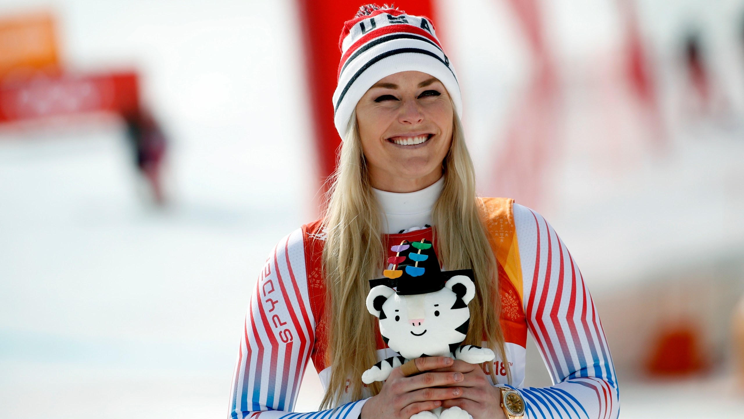 FILE - Bronze medal winner Lindsey Vonn, of the United States, smiles during the flower ceremony for the women's downhill at the 2018 Winter Olympics in Jeongseon, South Korea, Feb. 21, 2018. (AP Photo/Christophe Ena, File)