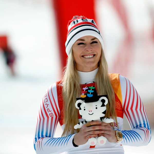 FILE - Bronze medal winner Lindsey Vonn, of the United States, smiles during the flower ceremony for the women's downhill at the 2018 Winter Olympics in Jeongseon, South Korea, Feb. 21, 2018. (AP Photo/Christophe Ena, File)