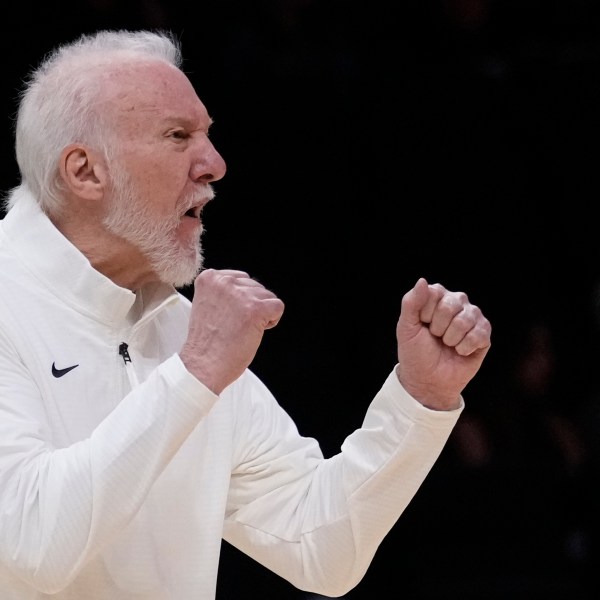 San Antonio Spurs head coach Gregg Popovich calls out to players during the first half of an NBA preseason basketball game against the Miami Heat, Tuesday, Oct. 15, 2024, in Miami. (AP Photo/Wilfredo Lee)