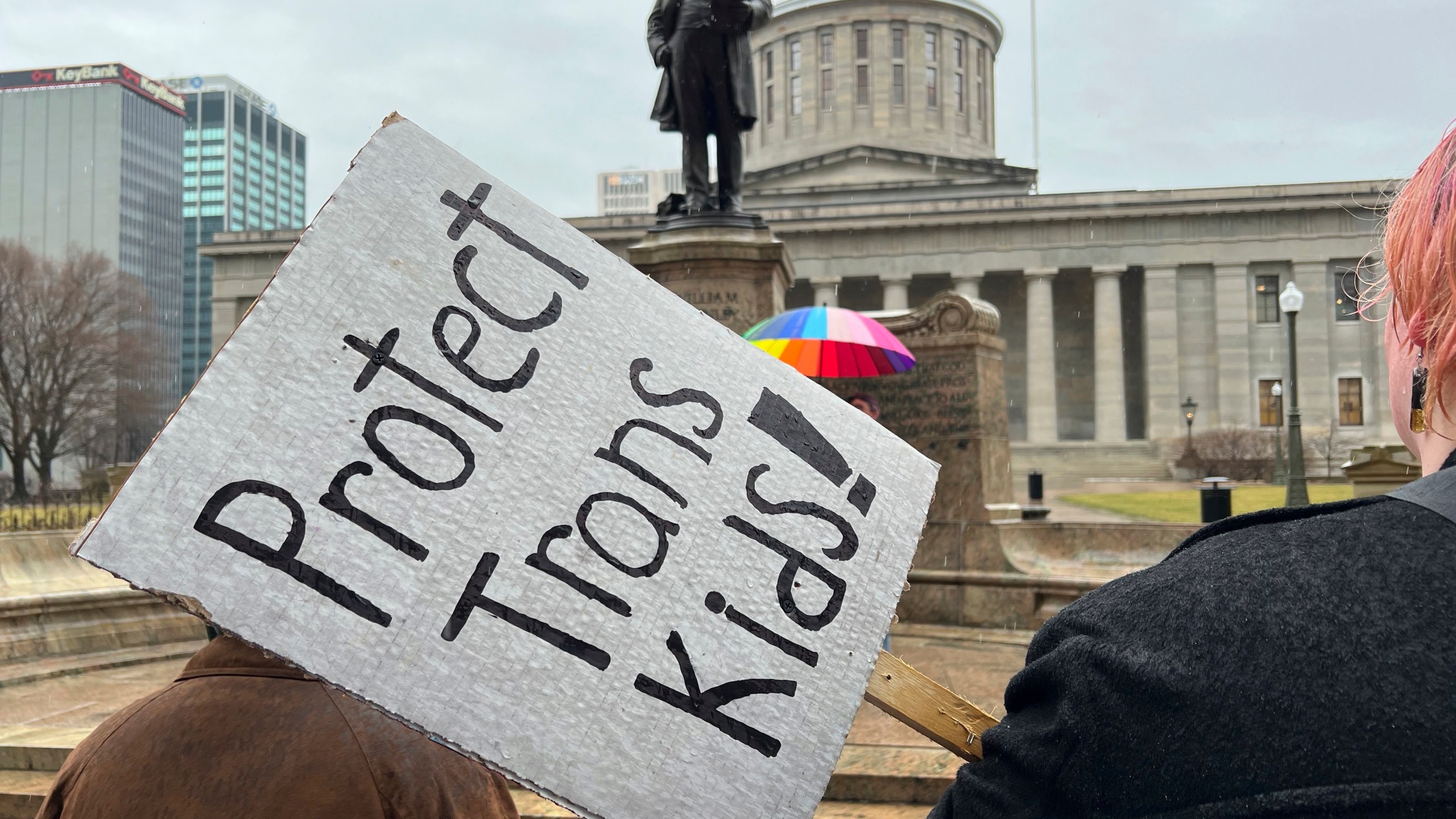 FILE - Protesters advocating for transgender rights and healthcare stand outside of the Ohio Statehouse, Jan. 24, 2024, in Columbus, Ohio. (AP Photo/Patrick Orsagost, File)