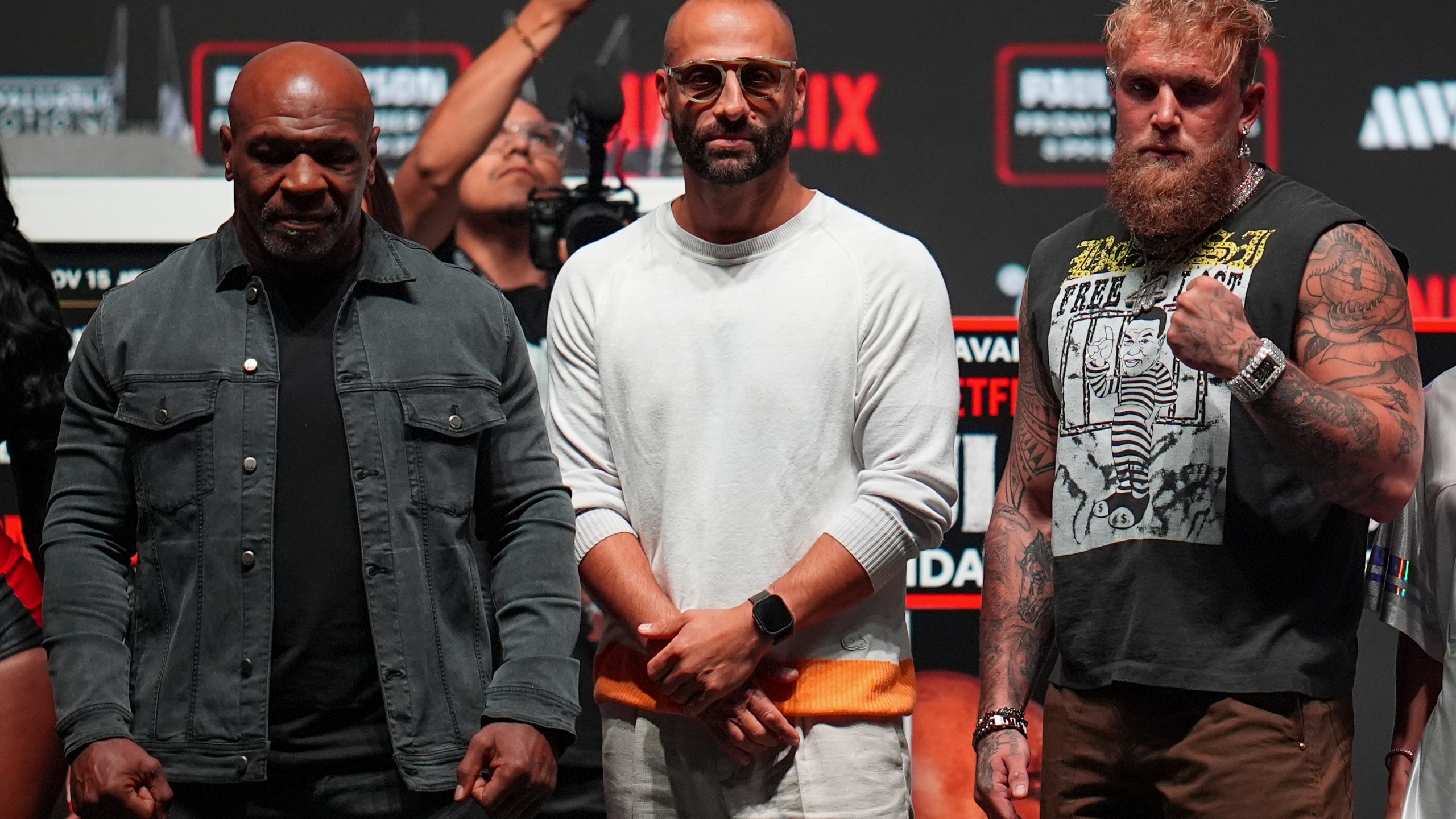 Mike Tyson, left, and Jake Paul, right, pose for photographs during a news conference ahead of their fight, Wednesday, Nov. 13, 2024, in Irving, Texas. (AP Photo/Julio Cortez)