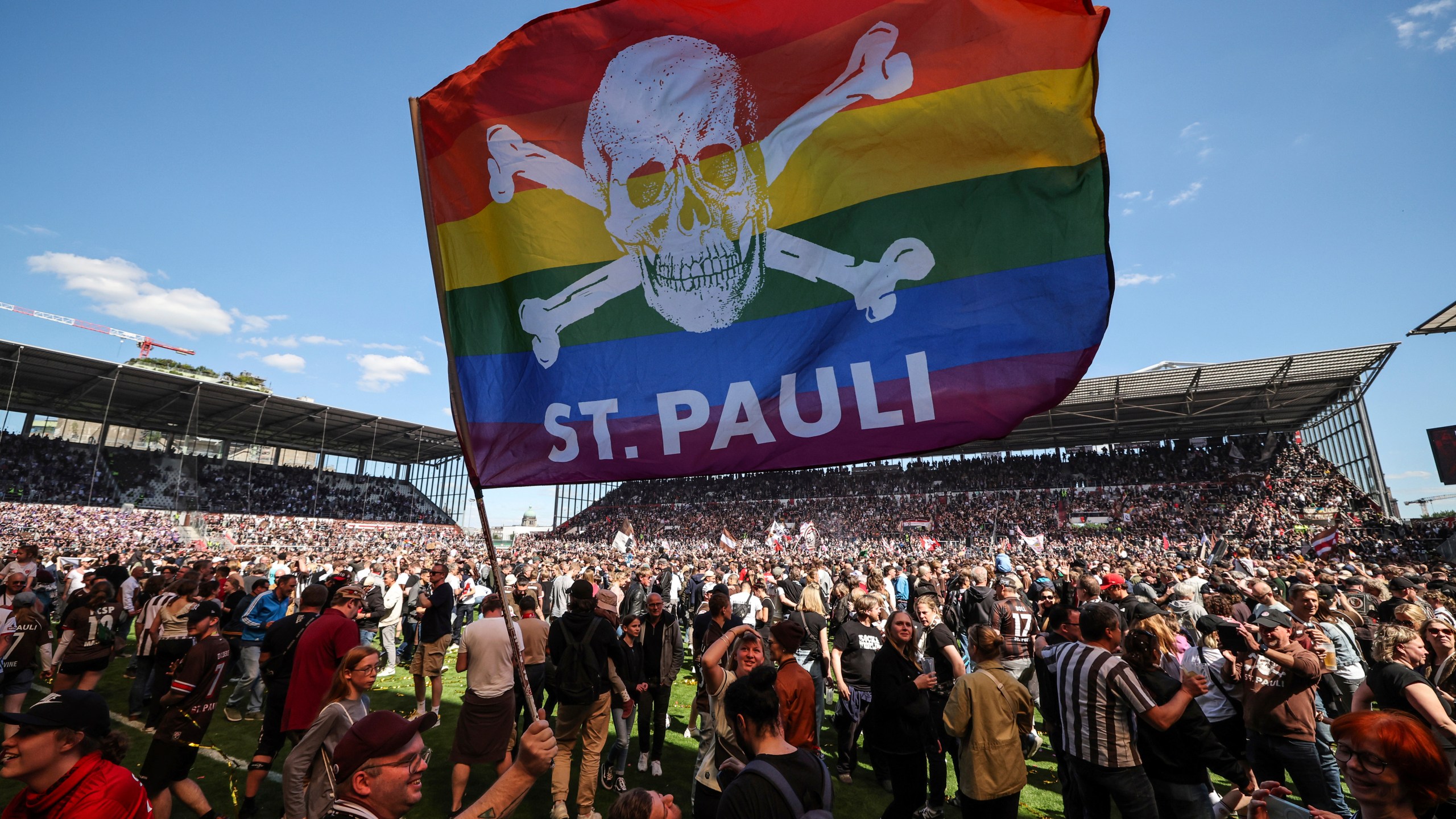 FILE - St. Pauli's fans invade the field after their team won 3-1 during a second division, Bundesliga soccer match at the Millerntor Stadium, in Hamburg, Germany, May 12, 2024. (Christian Charisius/dpa via AP File)