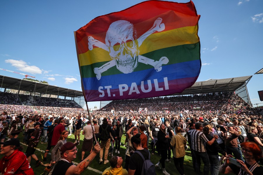 FILE - St. Pauli's fans invade the field after their team won 3-1 during a second division, Bundesliga soccer match at the Millerntor Stadium, in Hamburg, Germany, May 12, 2024. (Christian Charisius/dpa via AP File)