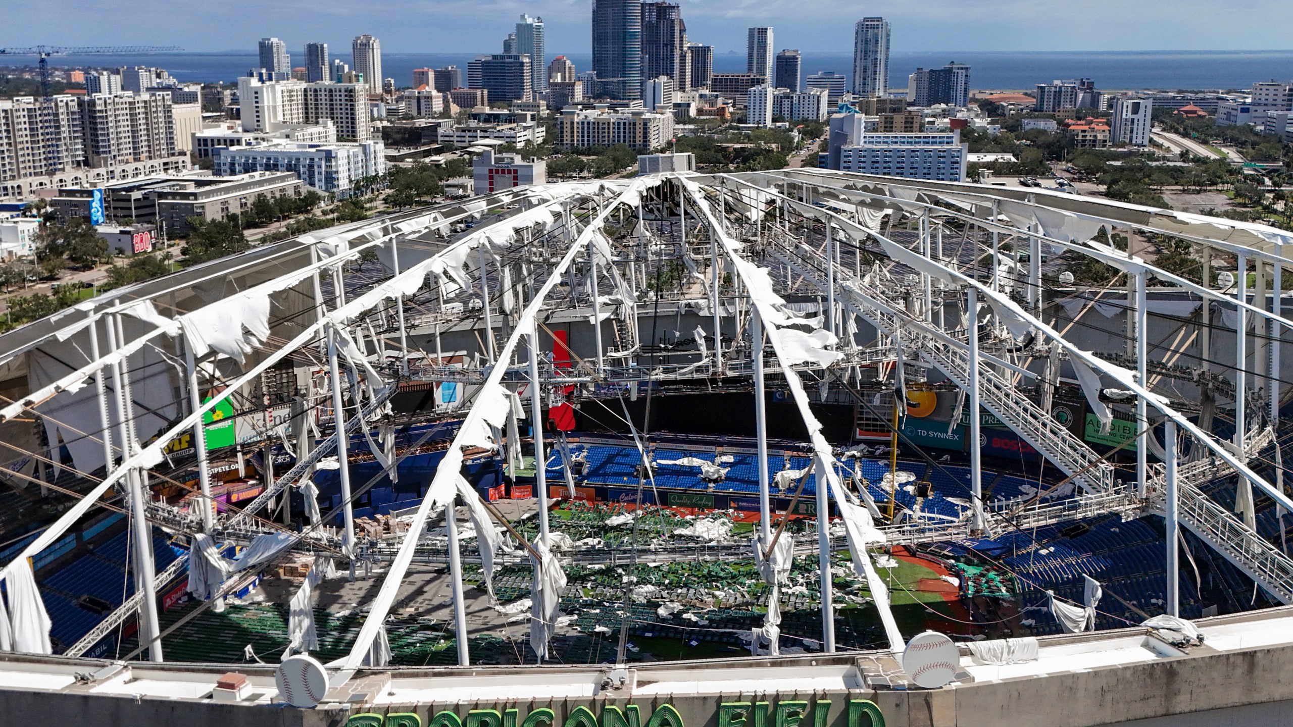 FILE - The roof of the Tropicana Field is damaged the morning after Hurricane Milton hit the region, Thursday, Oct. 10, 2024, in St. Petersburg, Fla. (AP Photo/Mike Carlson, File)