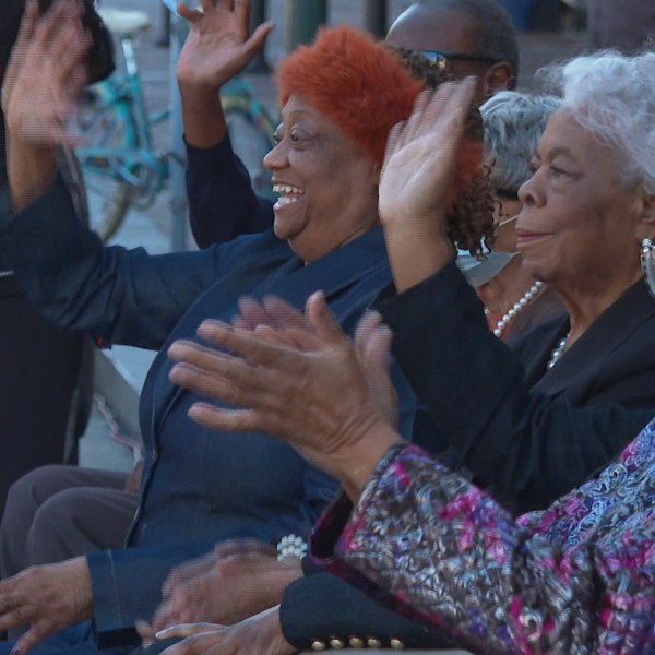 Civil rights activists, from left to right, Gail Etienne, Dorothy Prevost and Dorotha Dodie Smith-Simmons watch marching bands pass by to celebrate the sixty-four-year anniversary of the New Orleans Four desegregating schools Thursday, Nov. 14, 2024, in New Orleans. (AP Photo/Stephen Smith)