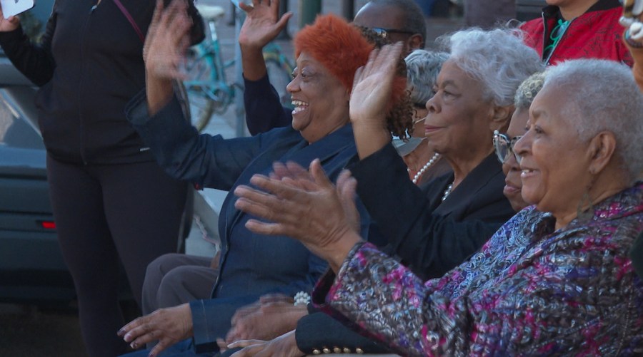 Civil rights activists, from left to right, Gail Etienne, Dorothy Prevost and Dorotha Dodie Smith-Simmons watch marching bands pass by to celebrate the sixty-four-year anniversary of the New Orleans Four desegregating schools Thursday, Nov. 14, 2024, in New Orleans. (AP Photo/Stephen Smith)