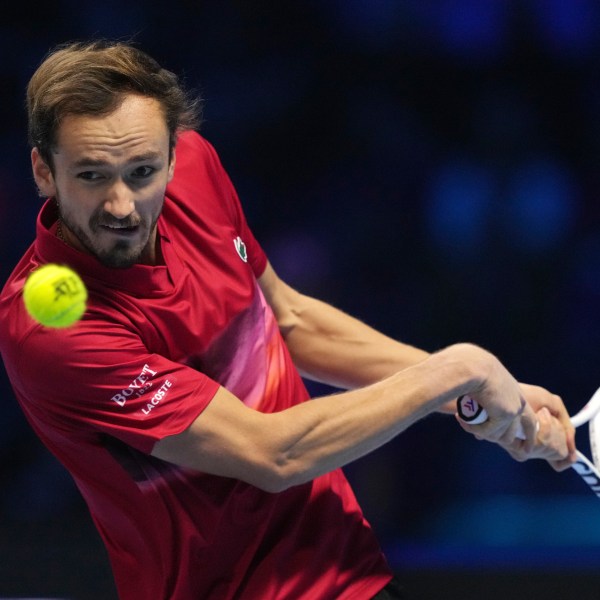 Russia's Daniil Medvedev returns the ball to Italy's Jannik Sinner during their singles tennis match of the ATP World Tour Finals at the Inalpi Arena, in Turin, Italy, Thursday, Nov. 14, 2024. (AP Photo/Antonio Calanni)