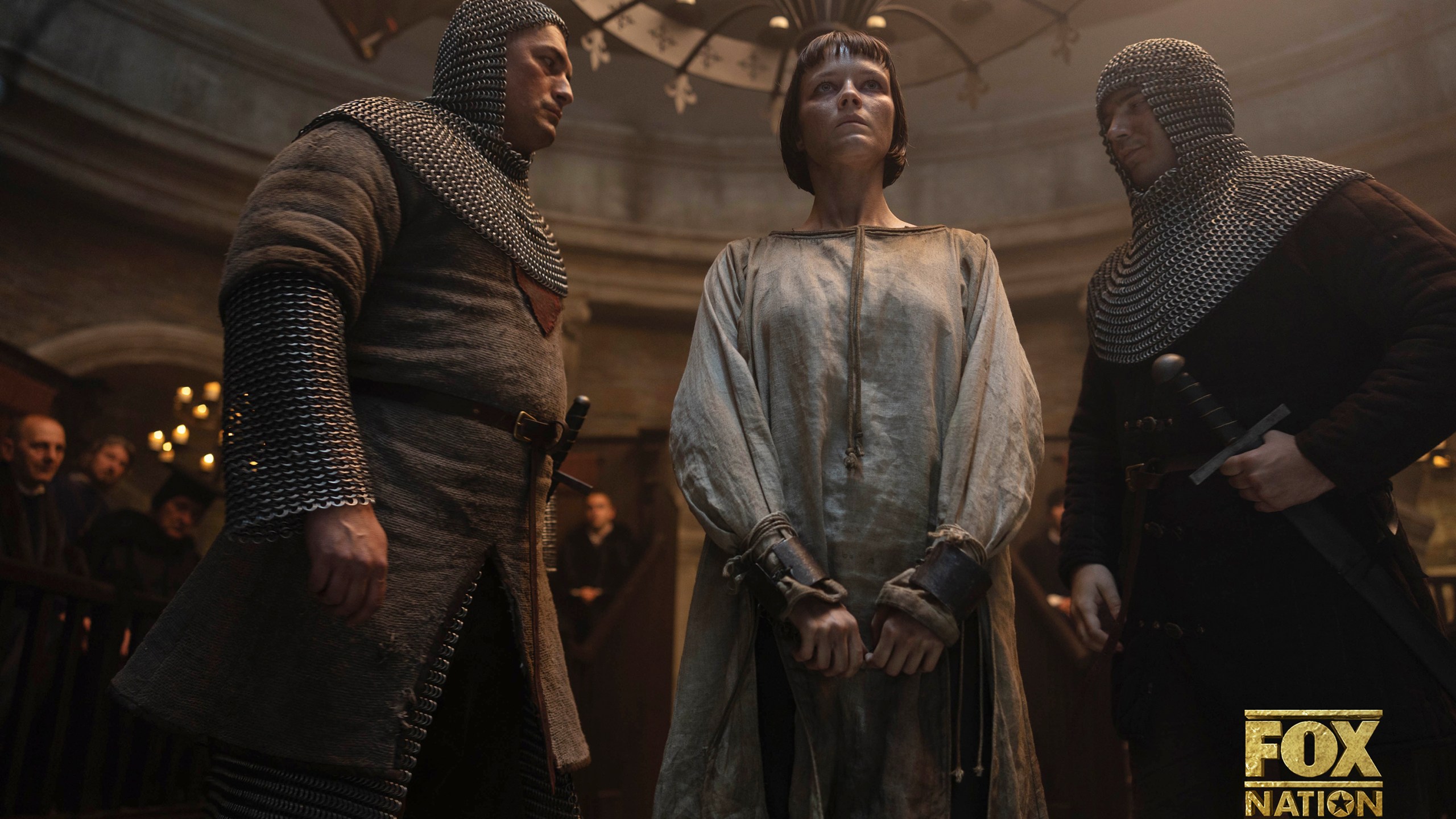 This image released by Fox Nation shows Liah O'Prey as Joan of Arc, center, in a scene from "Martin Scorsese Presents: The Saints," a new docudrama series by Martin Scorsese. (Slobodan Pikula/Fox Nation via AP)