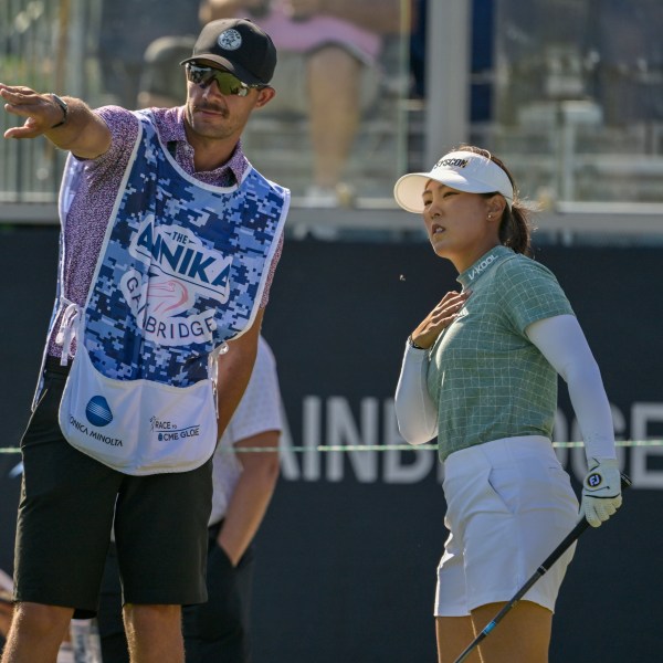 Jiwon Jeon, right, of South Korea, talks with her caddy on the first tee during the first round of The Annika golf tournament at Pelican Golf Club, Thursday, Nov. 14, 2024, in Belleair, Fla. (AP Photo/Steve Nesius)