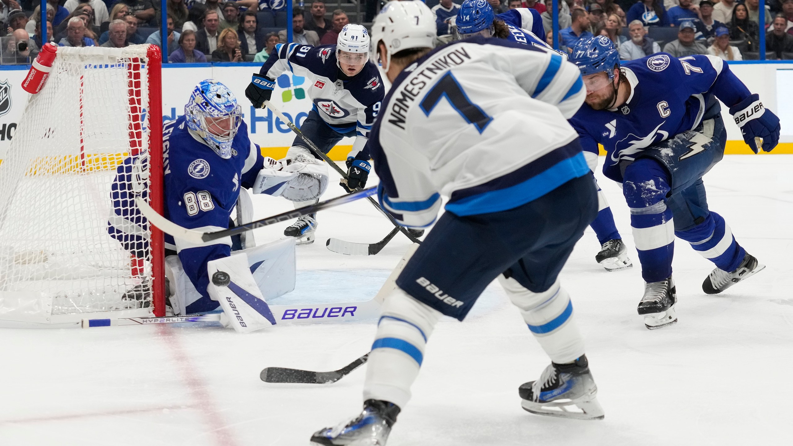 Tampa Bay Lightning goaltender Andrei Vasilevskiy (88) stops a shot by Winnipeg Jets center Vladislav Namestnikov (7) during the third period of an NHL hockey game Thursday, Nov. 14, 2024, in Tampa, Fla. (AP Photo/Chris O'Meara)