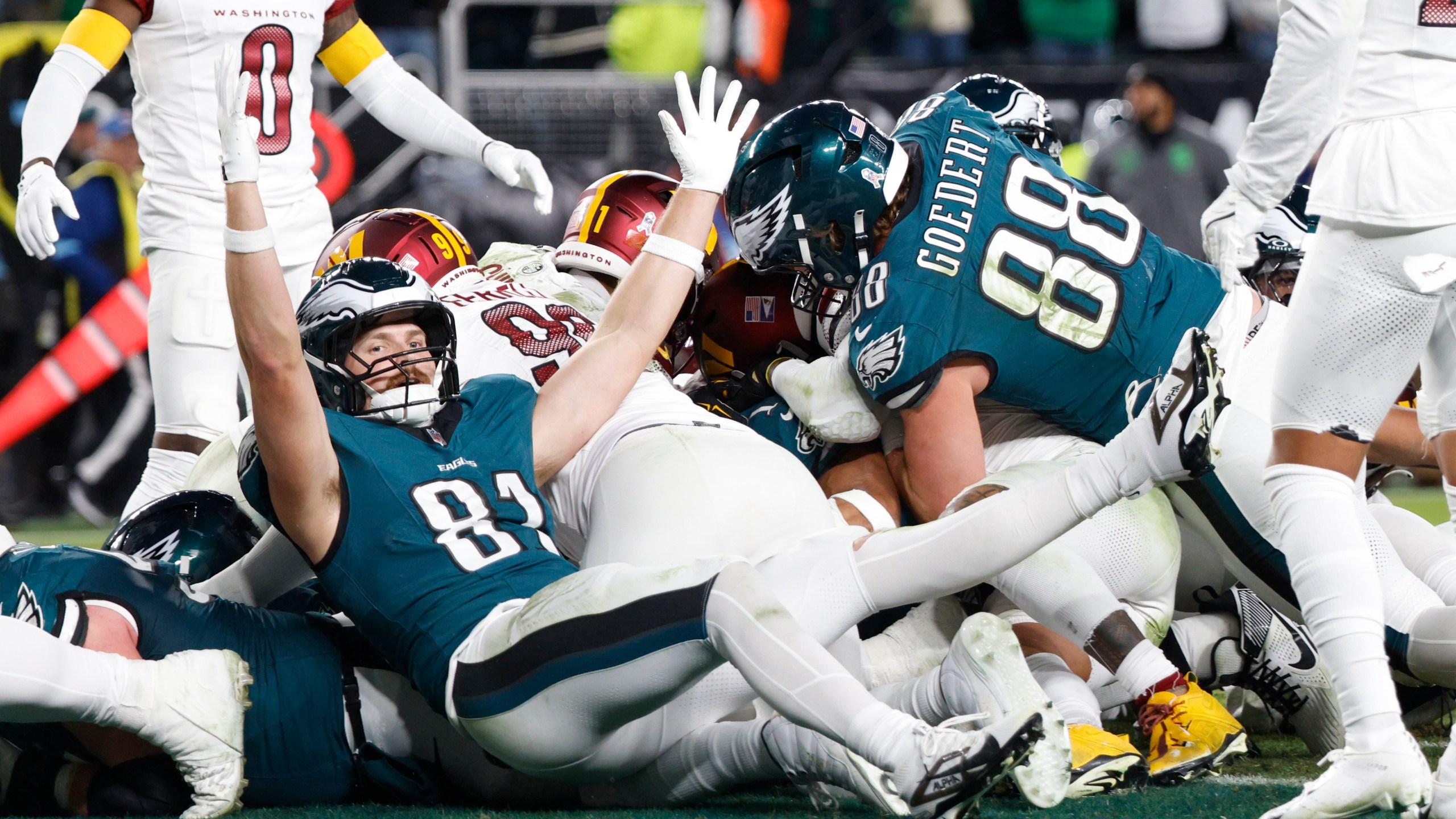 Philadelphia Eagles tight end Grant Calcaterra (81) celebrates a 1-yard touchdown by teammate Jalen Hurts during the second half of an NFL football game against the Washington Commanders Thursday, Nov. 14, 2024, in Philadelphia. (AP Photo/Laurence Kesterson)